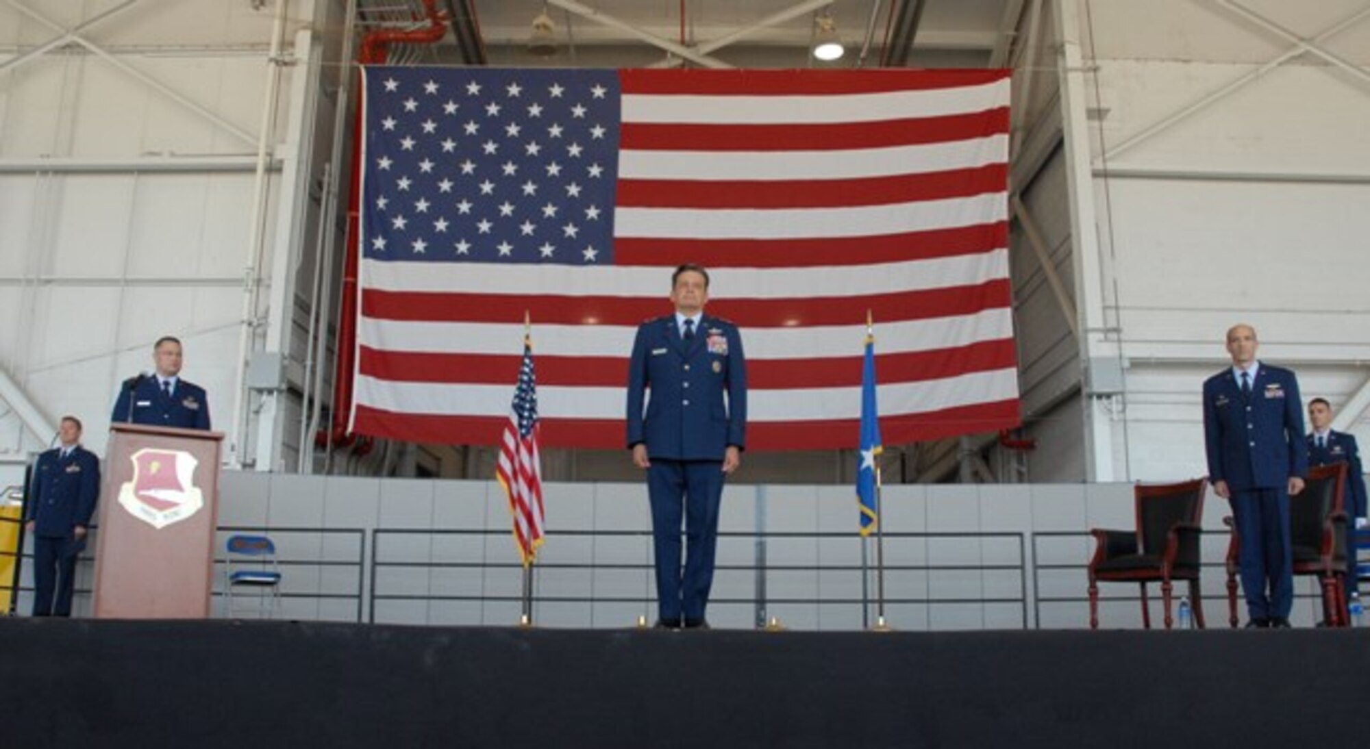Maj. Gen. Frank Padilla, 10th Air Force commander, center, and Col. Jeffrey Mineo, 940th Wing commander, right, stand at attention during the 940th re-designation ceremony July 11. The ceremony officially deactivated the 940th Air Refueling Wing and stood up the 940th Wing. (Photo by Tech. Sgt. Luke Johnson) 
