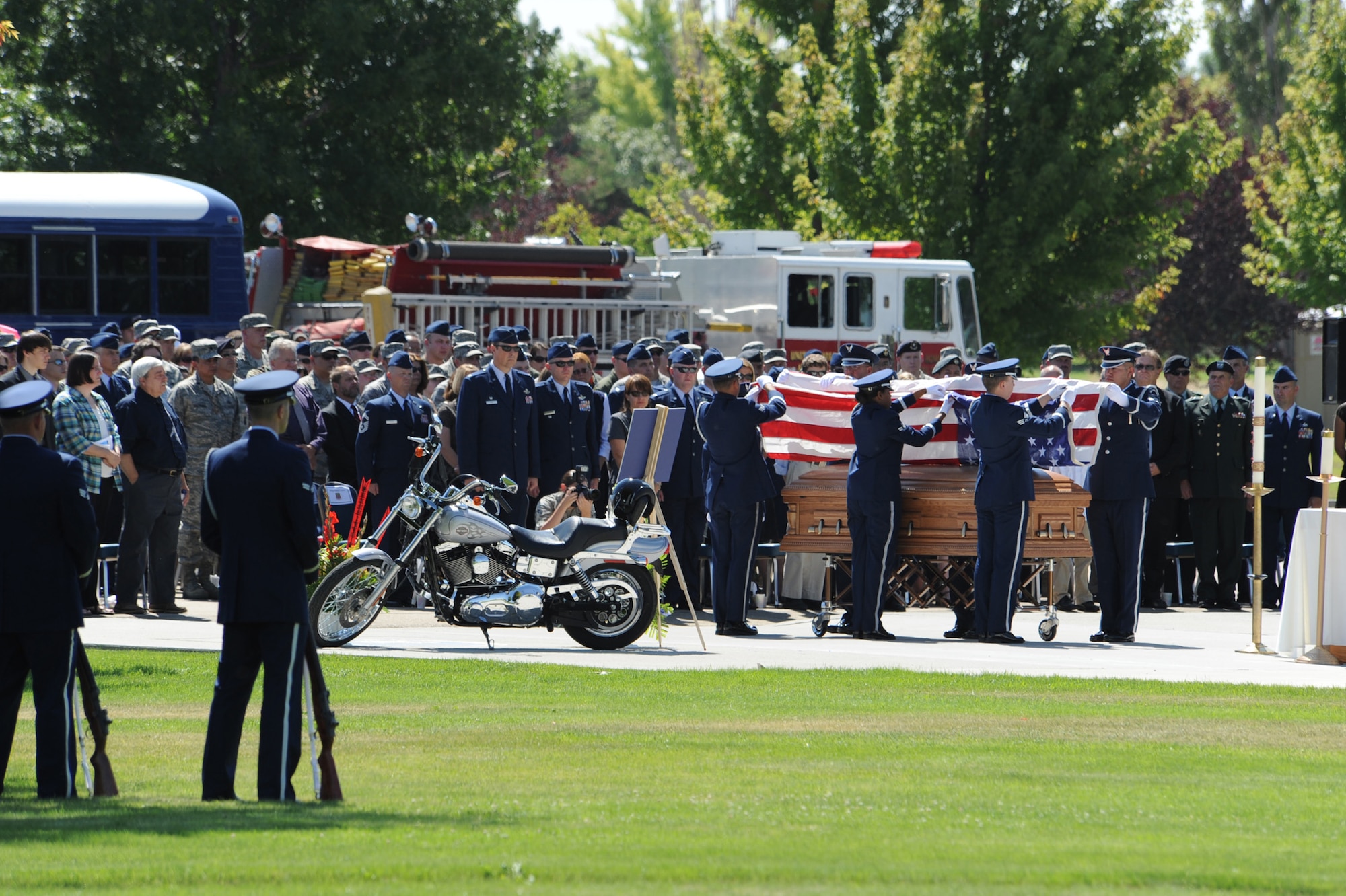 MOUNTAIN HOME AIR FORCE BASE, Idaho – The Mountain Home Air Force Base Honor Guard folds the U.S. flag that was draped on the casket of Capt. Mark Zampogna, who died July 11 when he was removed from medical life support equipment, before presenting it to Jennifer Zampogna during a memorial service at Holt Park July 17. The captain, from the 366th Operations Support Squadron, had been at St. Alphonsus Hospital in Boise, Idaho, in critical condition since July 6 after he was severely injured in a vehicle accident near McCall, Idaho. (U.S. Air Force photo by Master Sgt. Timothy Cook)