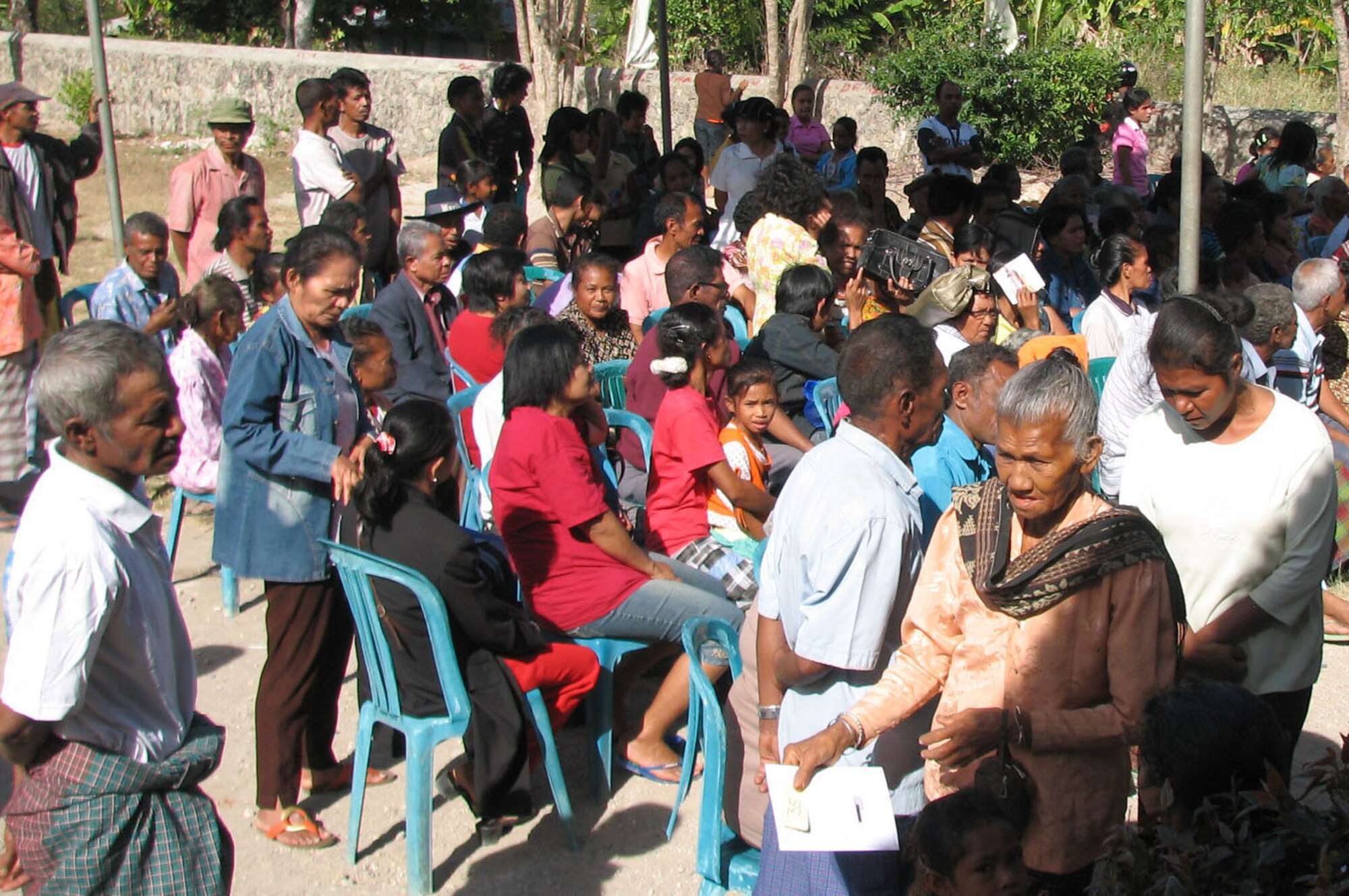 Local residents form a line prior to the opening of a clinic in Naioni, Indonesia, July 17.  U.S. and Indonesian military medical professionals, one local doctor, and six interpreters worked side-by-side at the clinic to treat patients as part of Operation Pacific Angel 2009.  During the first day July 16, the clinic saw 329 patients. Pacific Angel is a Pacific Air Forces humanitarian assistance operation led by 13th Air Force at Hickam Air Force Base, Hawaii. (U.S. Air Force photo/Senior Master Sgt. Russell Dodson)