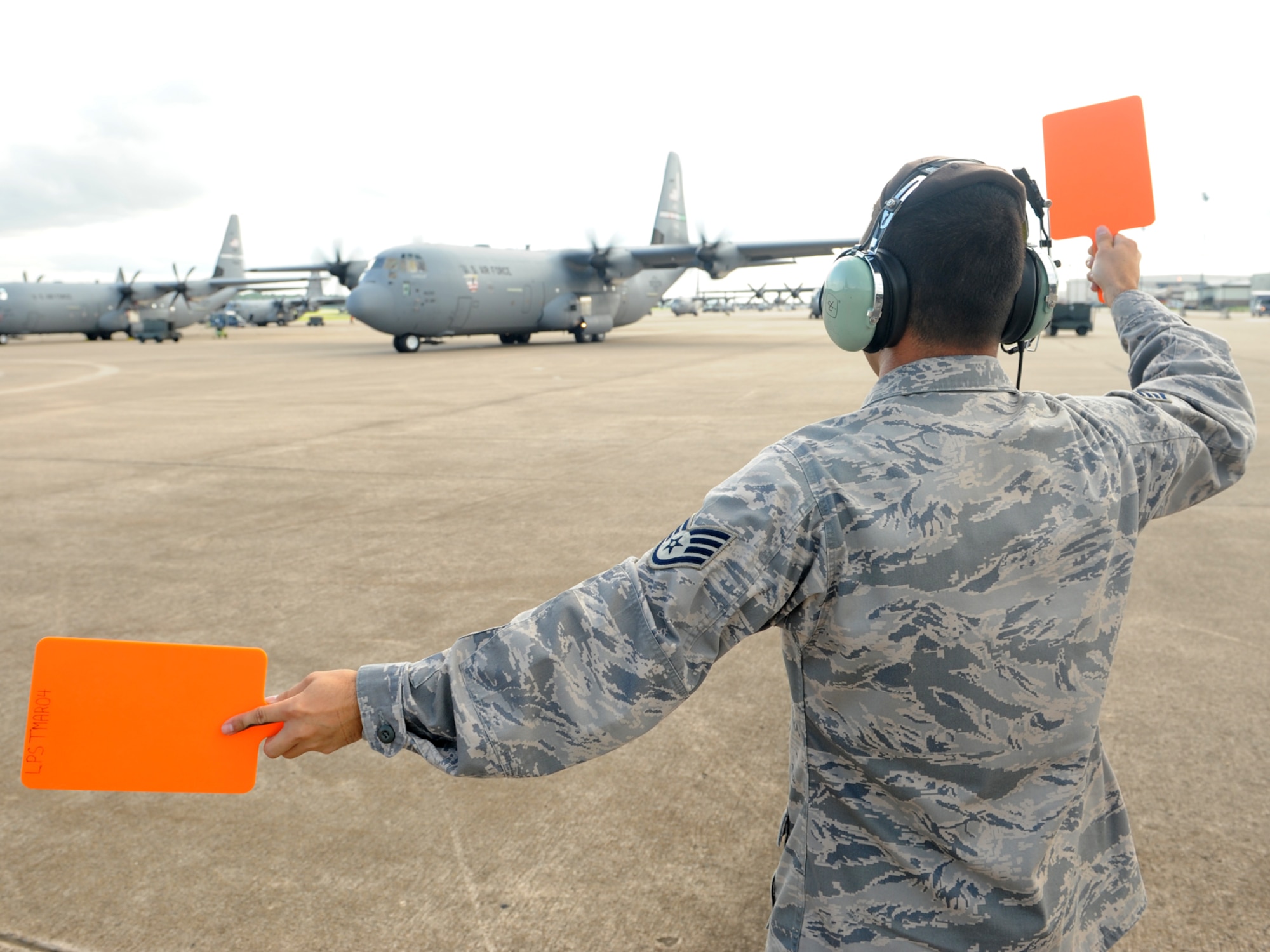 LITTLE ROCK AIR FORCE BASE, Ark. -- Staff Sgt. Fabian Balderrama, 19th Aircraft Maintenance Squadron crew chief, marshals a C-130J carrying the 19th Airlift Wing Rodeo team here July 17. (U. S. Air Force photo by Senior Airman Jim Araos)