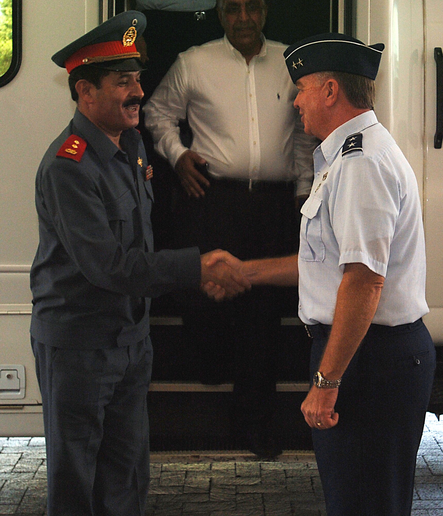 Maj. Gen. Tom Travis, 59th Medical Wing commander (right) welcomes Maj. Gen. Mohammad Dawran, Afghan National Army Air Corps commander, to Wilford Hall Medical Center July 17.  General Dawran toured the hospital's emergency department and received briefings on en-route care, critical care air transport teams and trauma. (U.S. Photo by Senior Airman Josie Kemp)