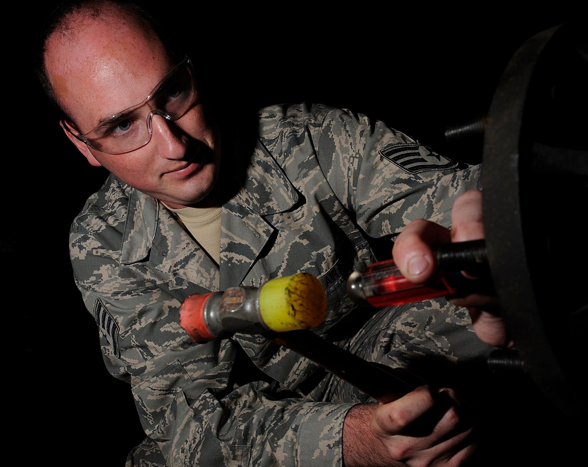 Staff Sgt. Jeffrey Goldsberry, 28th Logistics Readiness Squadron vehicle maintenance craftsman, seats a wheel bearing cover while changing brakes on a vehicle here, July 15. The vehicle maintenance shop routinely changes breaks on government vehicles base wide.(U.S. Air Force photo/Airman 1st Class Joshua J. Seybert)