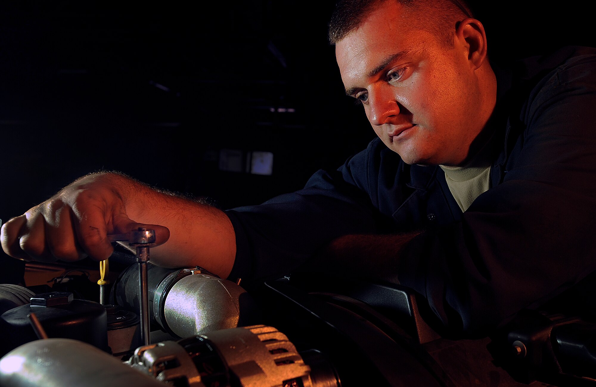 Staff Sgt. Kevin Jones, 28th Logistics Readiness Squadron vehicle maintenance craftsman, loosens a bolt while replacing an exhaust gas recirculation valve on a bio-diesel engine truck here, July 15. The exhaust gas recirculation valve recirculates unburned fuel back through the engine intake to allow cleaner emissions. (U.S. Air Force photo/Airman 1st Class Joshua J. Seybert)