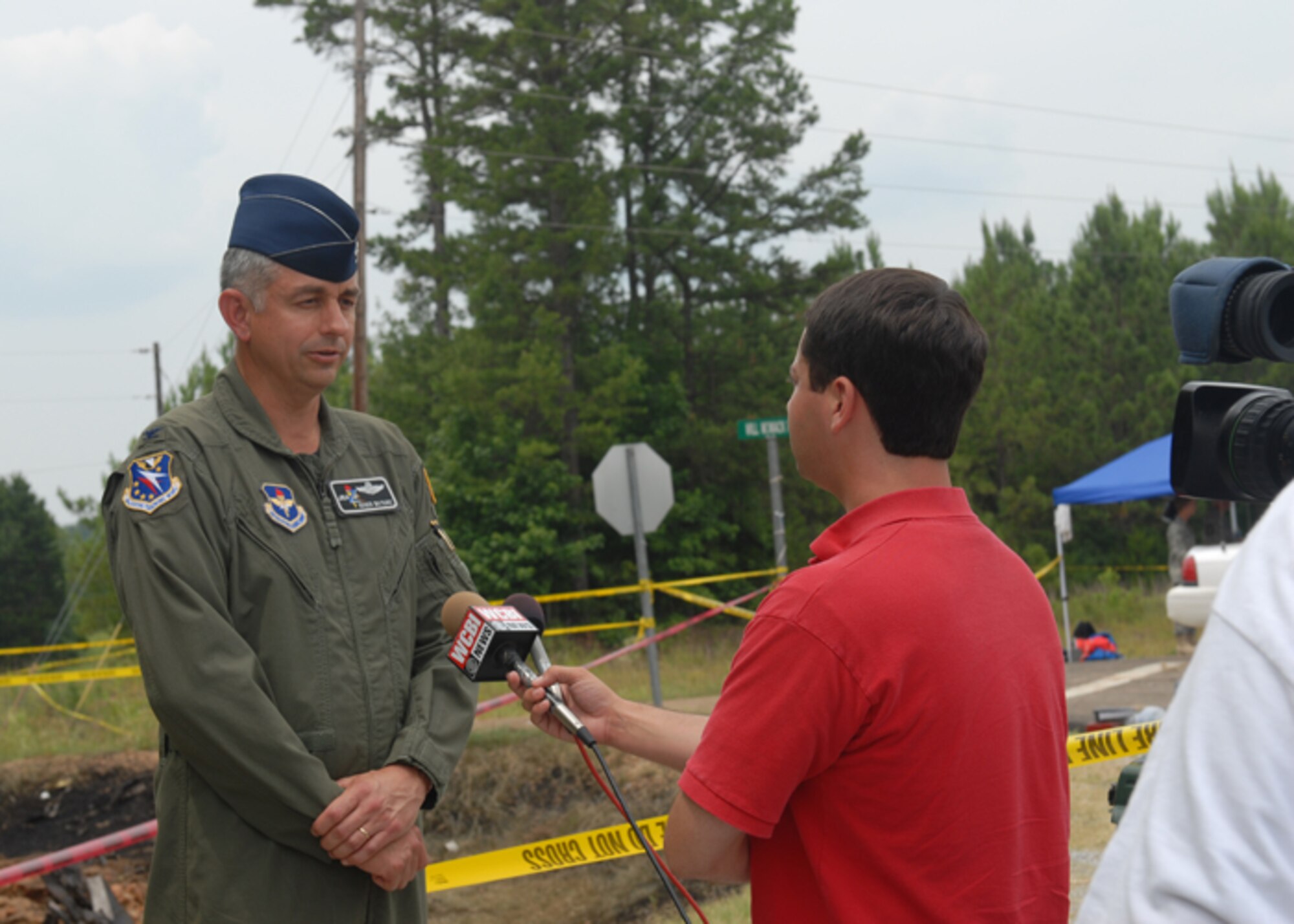 Col. Roger Watkins, 14th Flying Training Wing commander, speaks to media representatives July 10 following the previous evening’s T-6 Texan II crash. The sole-student pilot aboard ejected safely prior to the aircraft impacting in a sparsely populated area 40 miles west of Columbus Air Force Base in Webster County. (U.S. Air Force photo/Melissa Duncan). 