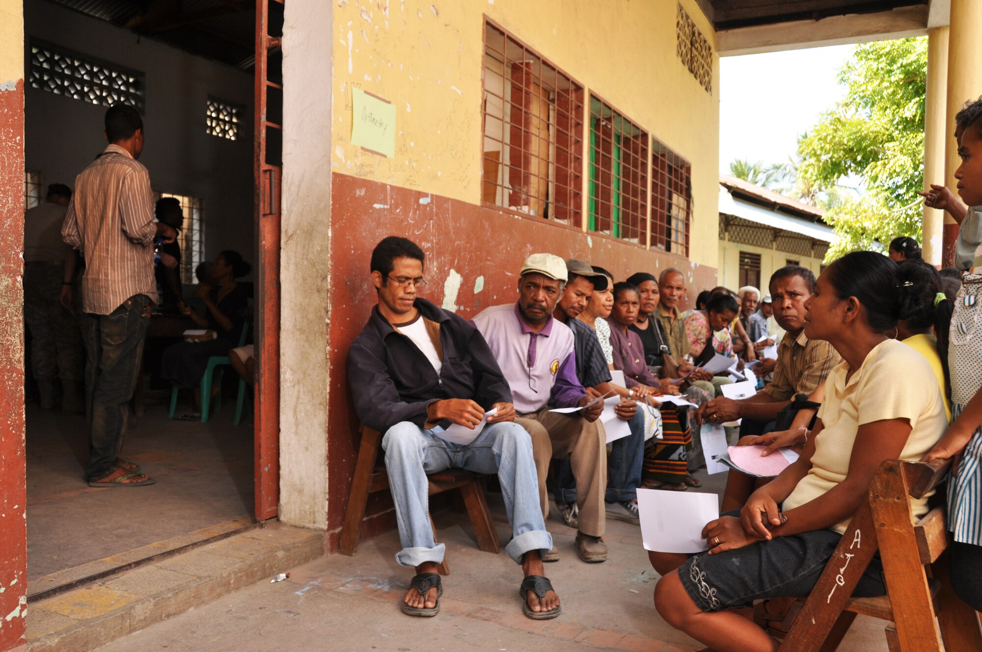 Local residents wait outside a makeshift optometry office for free exams at a clinic set up July 16 in Dili, Timor Leste. East Timorese and U.S. officials set up the clinic as part of Operation Pacific Angel 2009, a Pacific Air Forces humanitarian assistance operation led by 13th Air Force at Hickam Air Force Base, Hawaii. (U.S. Air Force photo/Tech. Sgt. Cohen A. Young) 