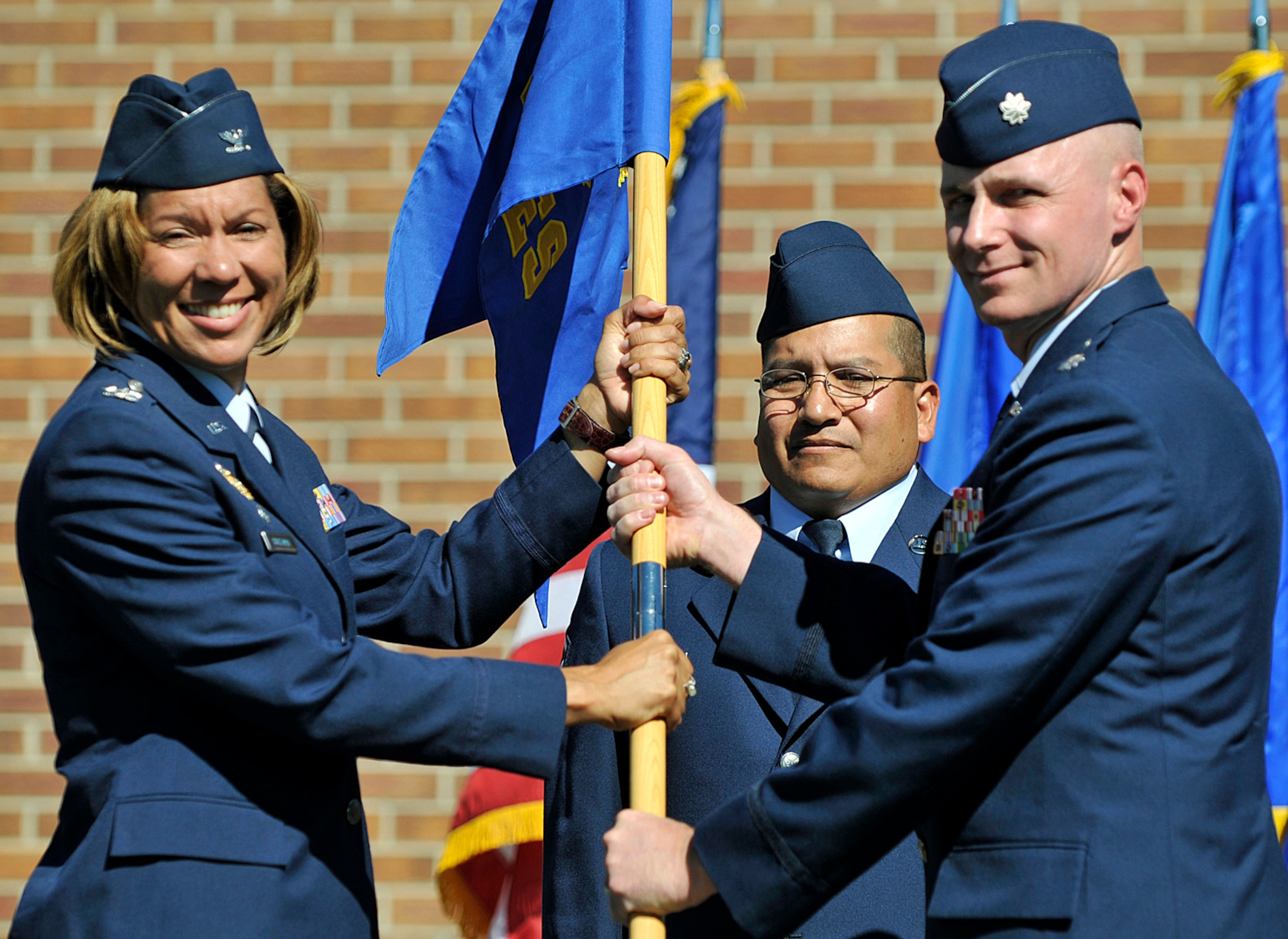PETERSON AIR FORCE BASE, Colo. -- Col. Emily Buckman, 21st Mission Support Group commander, passes the 21st Civil Engineer Squadron colors to Lt. Col. Arno Bischoff, the new CE commander, during the 21st CES change of command July 16. Colonel Bischoff arrives from Tyndall Air Force Base, Fla., where he was the Detachment 1, 823rd Red Horse Squadron commander, and replaces Lt. Col. Gary Schneider, who will attend the Industrial College of the Armed Forces at Fort McNair. (Air Force photo by Larry Hulst)