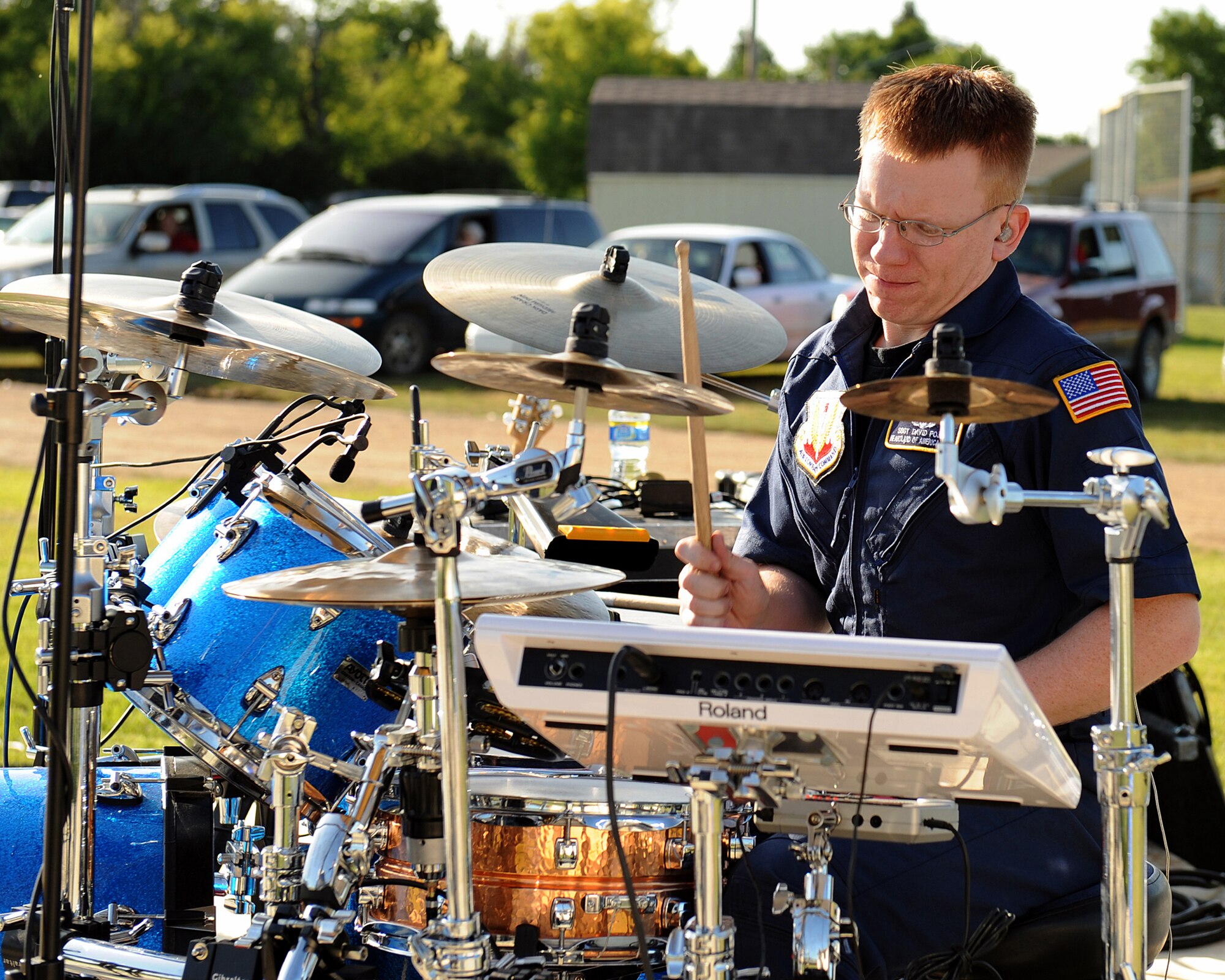 BERTHOLD, N.D. -- Staff Sgt. David Pojar, a member of Night Wing, performs a percussion solo during a concert here July 16. Night Wing is the country/rock showcase group of the United States Air Force Heartland of America Band. Night Wing inspires audiences to increased patriotism through their unique vocal blend and amazing musicianship while raising awareness of our expeditionary Airmen serving around the globe. (U.S. Air Force  photo by Tech. Sgt. Linda C. Miller)