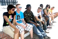 7/12/2009 - Airmen from the 343rd Training Squadron take a break from serving spaghetti during the 100 Club of San Antonio's annual spaghetti dinner fundraiser July 12. The fundraiser raised money for the families of fallen police officers and firefighters who have died in the line of duty. (U.S. Air Force photo/Zahra Farah)                                