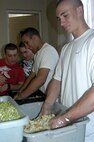 7/12/2009 - Airmen from the 343rd Training Squadron prepare salad during the 100 Club of San Antonio's annual spaghetti dinner fundraiser July 12. The fundraiser raised money for the families of fallen police officers and firefighters who have died in the line of duty. (U.S. Air Force photo/Zahra Farah)
