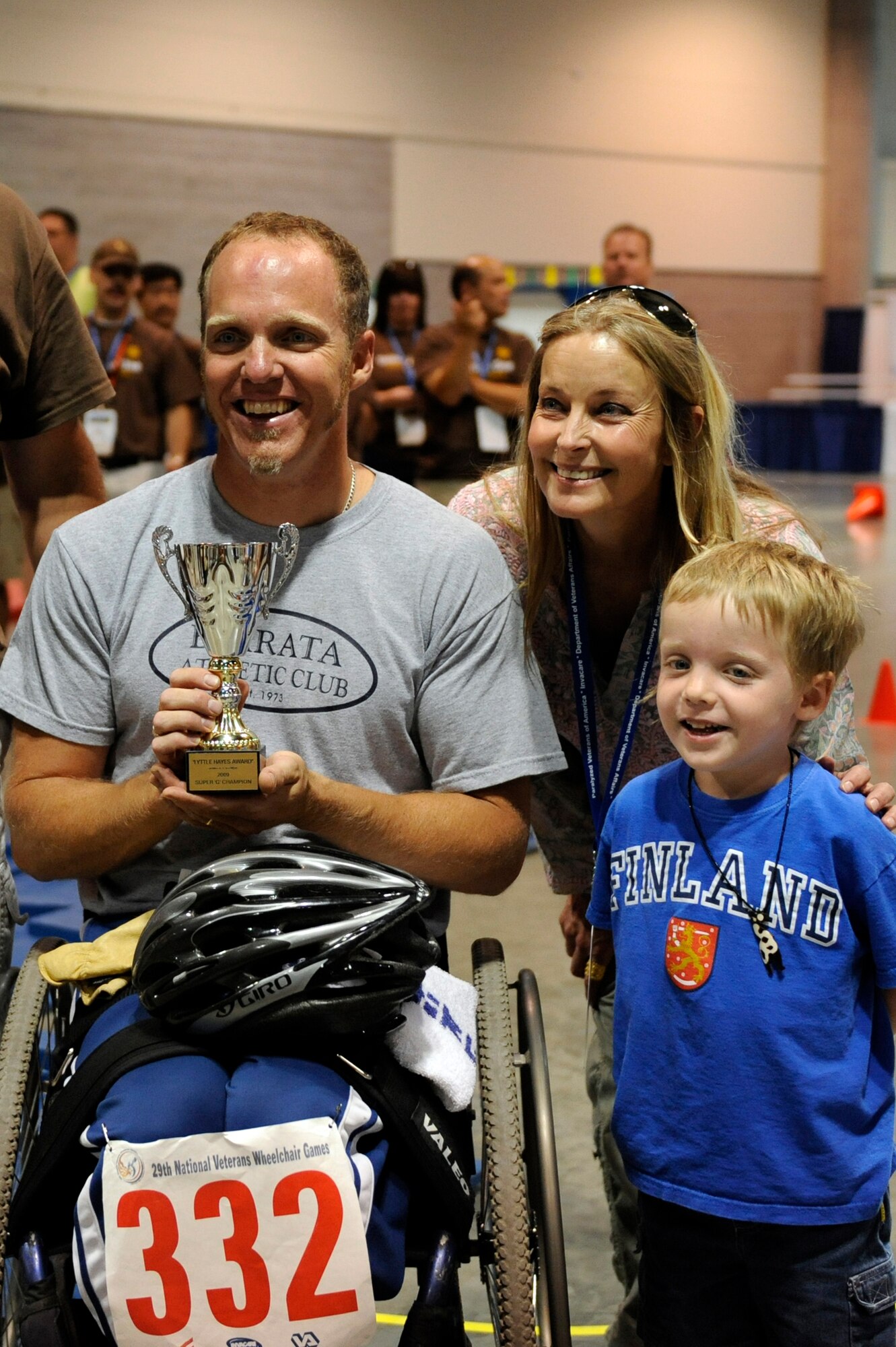 Sean Halsted smiles for the cameras with his son, Ethan, 5, and Bo Derek after winning first place in the slalom super G competition during the 29th National Veterans Wheelchair Games July 16 in Spokane, Wash. Mr. Halsted is an Air Force veteran and resides in Rathdrum, Idaho. Bo Derek is an actress. (U.S. Air Force photo/Staff Sgt. Desiree N. Palacios)