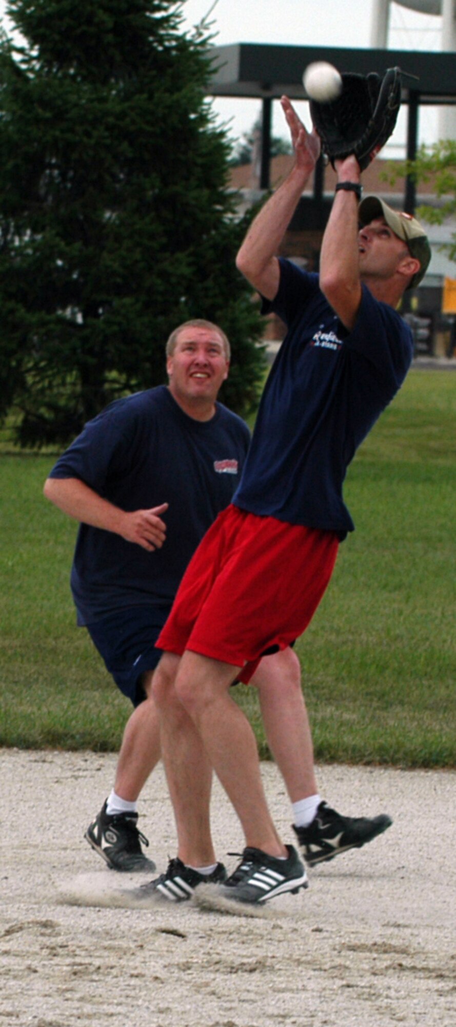 GRISSOM AIR RESERVE BASE, Ind.,-- Joshua Richman, second baseman for the DOD police softball team, attempts to snags an infield pop-up as short stop Shawn Perry looks on. The DOD Police took the field against the 434th Seasonal Training Flight during intramural play at Grissom. Intramural sports are great for physical fitness as well as boosting morale, encouraging teamwork and helps build camaraderie. (U.S. Air Force photo/Senior Airman Carl Berry)