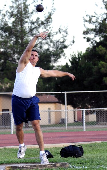 Staff Sgt. Shaun Crum, 39th Communications Squadron, puts forth his best toss in the shot put competition during the Under the Lights Track Meet at Incirlik Air Base, Turkey. The event was sponsored by the Health and Wellness Center, the Sexual Assault Response Coordinator and the Fitness Center to promote fitness and increase base morale. Squadrons earned points throughout the event to determine the winner of the Travelling Unit Fitness Award. The winning squadron was the 728th Air Mobility Squadron. (U.S. Air Force photo/Staff Sgt. Raymond Hoy)