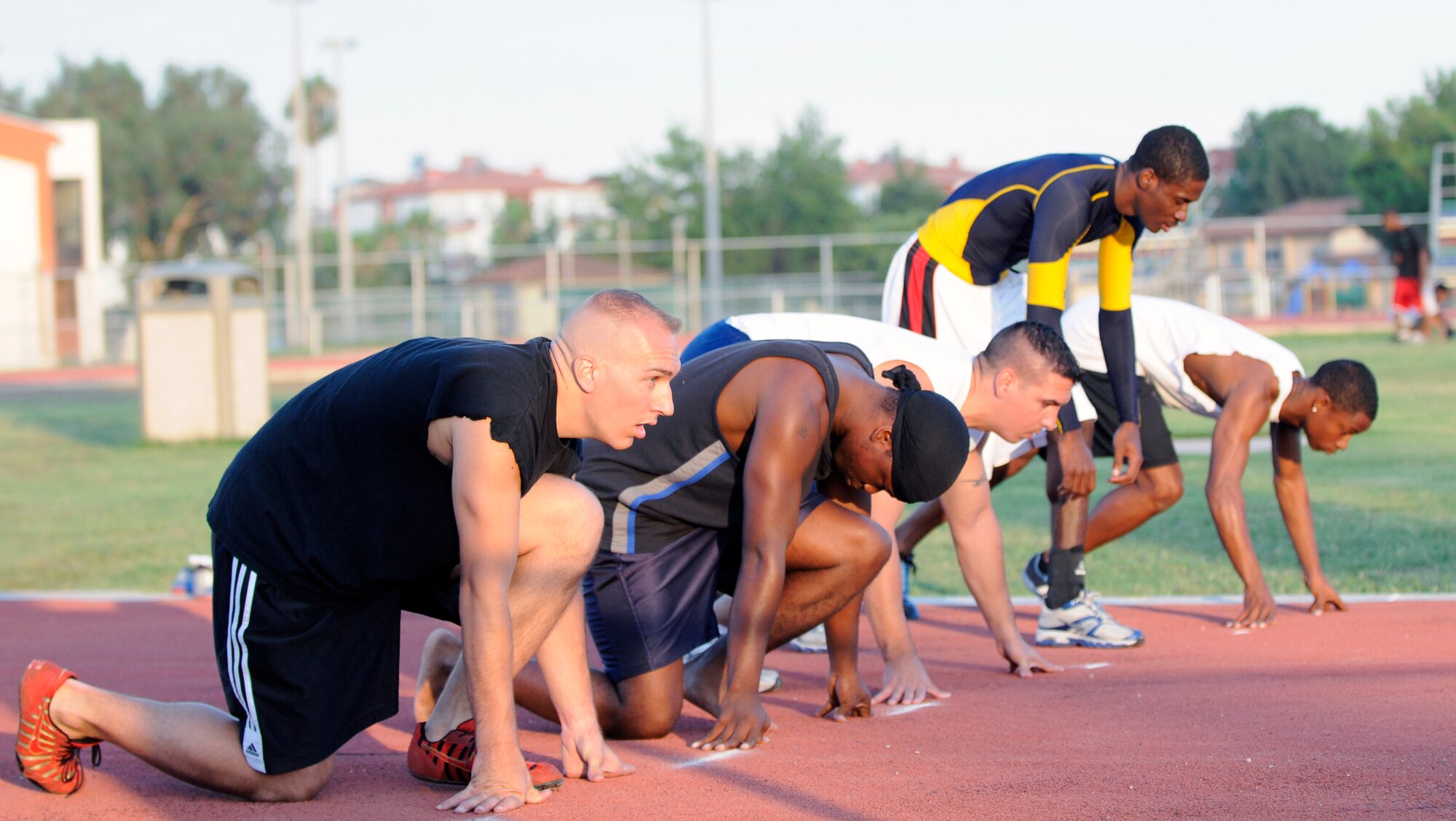 Members of Team Incirlik line up for the 100 meter race during the Under the Lights Track Meet at Incirlik Air Base, Turkey. The event was sponsored by the Health and Wellness Center, the Sexual Assault Response Coordinator and the Fitness Center to promote fitness and increase base morale. Squadrons earned points throughout the event to determine the winner of the Travelling Unit Fitness Award. The winning squadron was the 728th Air Mobility Squadron. (U.S. Air Force photo/Staff Sgt. Raymond Hoy)