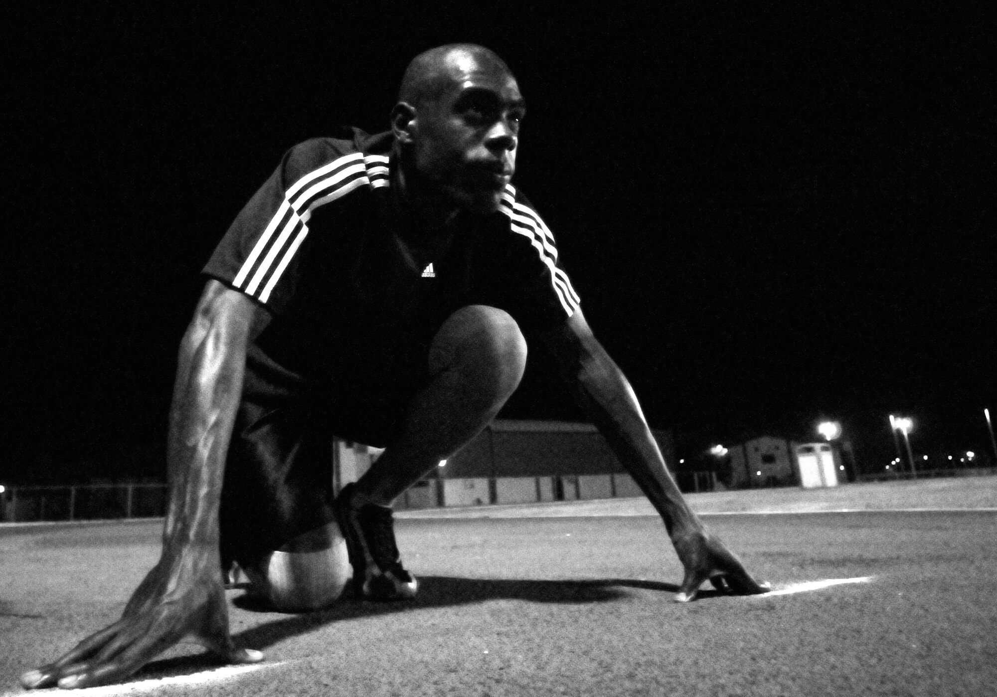 Staff Sgt. Martin Wallace, 39th Contracting Squadron, lines up for the 100 meter race during the Under the Lights Track Meet at Incirlik Air Base, Turkey. The event was sponsored by the Health and Wellness Center, the Sexual Assault Response Coordinator and the Fitness Center to promote fitness and increase base morale. Squadrons earned points throughout the event to determine the winner of the Travelling Unit Fitness Award. The winning squadron was the 728th Air Mobility Squadron. (U.S. Air Force photo/Staff Sgt. Raymond Hoy)
