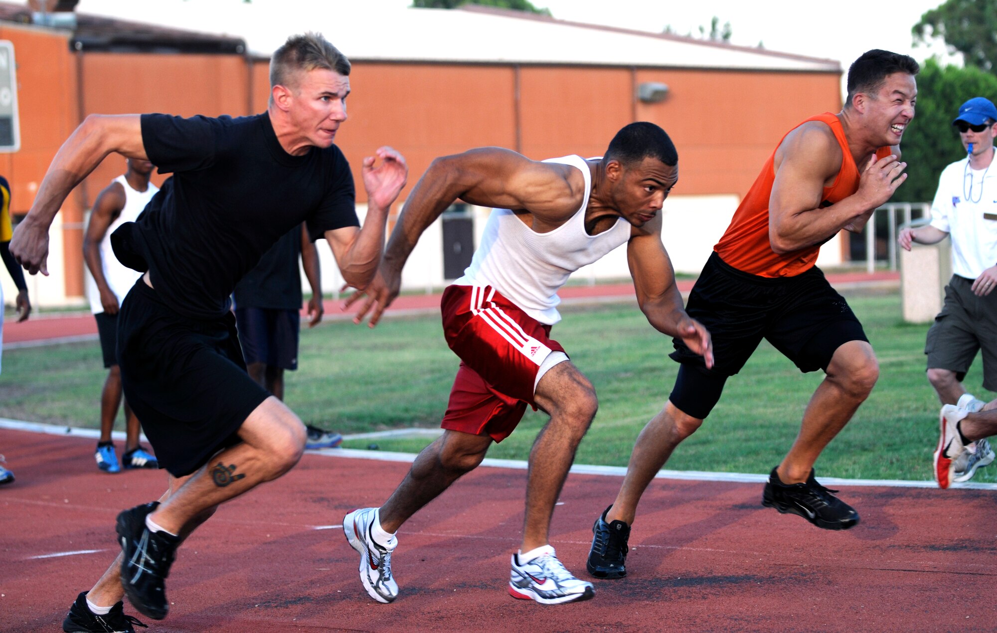 Members of Team Incirlik push off from the starting line in the 100 meter race Wednesday, 25 July 2009 during the Under the Lights Track Meet at Incirlik Air Base, Turkey. The event was sponsored by the Health and Wellness Center, the Sexual Assault Response Coordinator and the Fitness Center to promote fitness and increase base morale. Squadrons earned points throughout the event to determine the winner of the Travelling Unit Fitness Award. The winning squadron was the 728th Air Mobility Squadron. (U.S. Air Force photo/ Staff Sgt. Raymond Hoy)