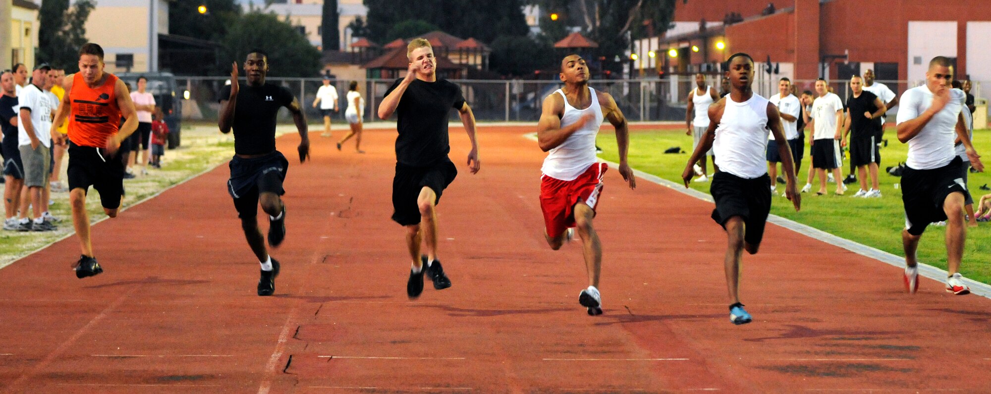 Members of Team Incirlik sprint 100 meters Wednesday, 25 July 2009 during the Under the Lights Track Meet at Incirlik Air Base, Turkey. The event was sponsored by the Health and Wellness Center, the Sexual Assault Response Coordinator and the Fitness Center to promote fitness and increase base morale. Squadrons earned points throughout the event to determine the winner of the Travelling Unit Fitness Award. The winning squadron was the 728th Air Mobility Squadron. (U.S. Air Force photo/ Staff Sgt. Raymond Hoy)