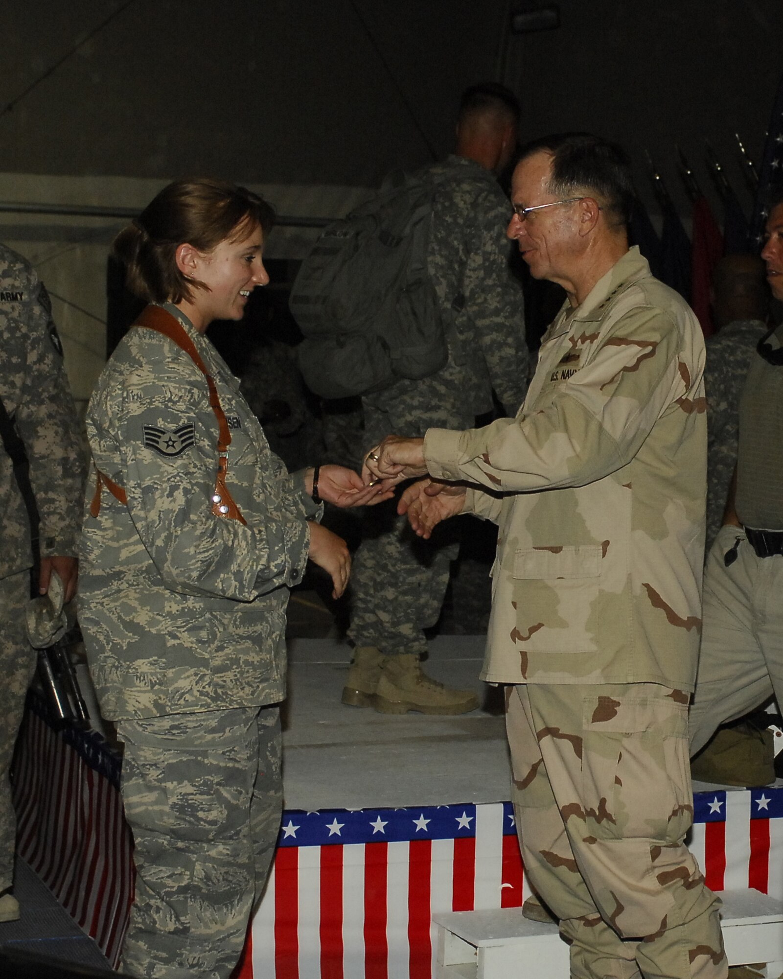 BAGRAM AIRFIELD, Afghanistan -- Staff Sgt. Patrice Hansen, 455th Air Expeditionary Wing Legal Office, receives a personal coin from Admiral Michael Mullen, the Chairman of the Joint Chiefs of Staff. Adm. Mullen discussed top issues with more than 300 servicemembers here July 14. Adm. Mullen made it a point to shake every single person's hand and offered a "thank you for what you're doing here in Afghanistan." Sergeant Hansen hails from Creole, La., and is deployed from Misawa Air Base, Japan. (U.S. Air Force photo/Tech. Sgt. John Jung)