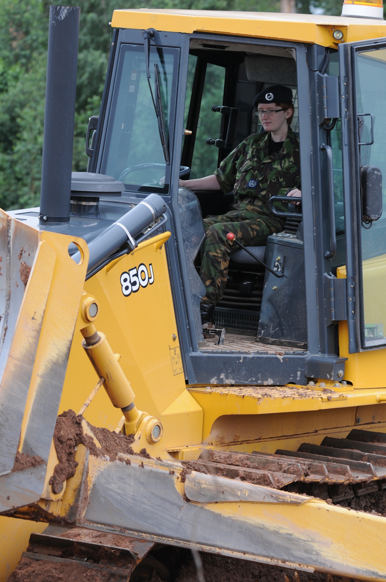 British Air Cadet Sgt. Louise Penman, Edinburgh, Scotland, operates a bulldozer during the cadet’s visit to Ramstein Air Base, Germany, July 14, 2009. Cadets visited Ramstein for a week of leadership development and contingency skills training. (U.S. Air Force photo by Airman 1st Class Caleb Pierce)