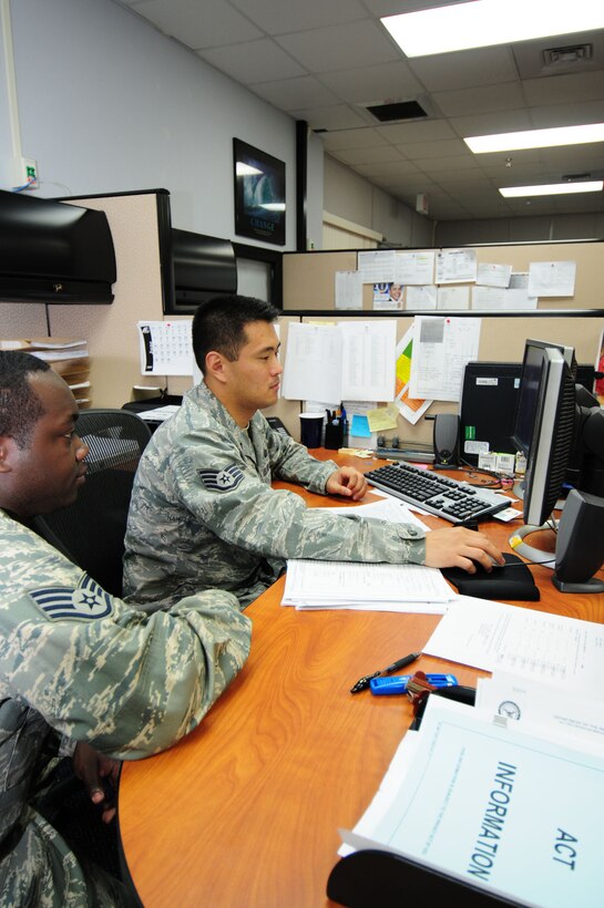 ANDERSEN AIR FORCE BASE, Guam - (Right to left) Staff Sgt. Chinwoo Mun, 36th Comptroller Squadron customer service technician, reviews overseas housing allowance rates with Staff Sgt. Derrick Spencer, 36th Wing Public Affairs broadcasting noncommissioned officer in charge, at the financial services office May 28. The FSO assists customers with all financial matters including travel vouchers, advance pay and debts. (U.S. Air Force photo by Tech. Sgt. Michael Boquette)