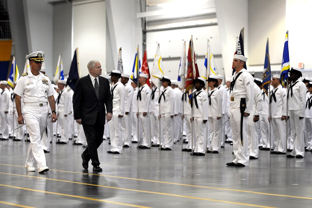 Navy Capt. John Peterson, commander of the Navy Recruit Training Command, and Defense Secretary Robert M. Gates perform a pass in review by Navy bootcamp graduates at Great Lakes Naval Training Center, Ill., July 17, 2009. DoD photo by Air Force Master Sgt. Jerry Morrison