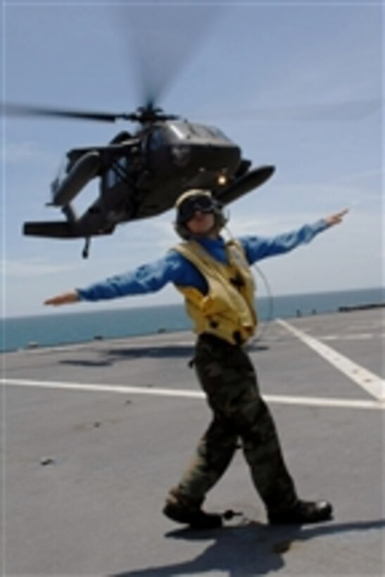 U.S. Navy Petty Officer 3rd Class Matthew Shaw directs a UH-60 Army Blackhawk helicopter based out of Managua, Nicaragua, during deck landing qualifications aboard the Military Sealift Command hospital ship USNS Comfort (T-AH 20) near Corinto, Nicaragua, on July 9, 2009.  The Comfort is participating in Continuing Promise 2009, a four-month humanitarian and civic assistance mission to Latin America and the Caribbean.  