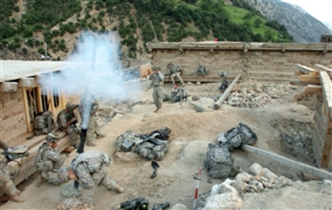 U.S. Army soldiers fire mortars at the fighting positions of opposing forces during a combat operation in the village of Barge Matal in the eastern Nuristan province of Afghanistan on July 12, 2009.  During the operation, U.S. soldiers from 1st Battalion, 32nd Infantry Regiment, 3rd Brigade Combat Team, 10th Mountain Division and Afghan National Security Forces secured the remote mountain village.  