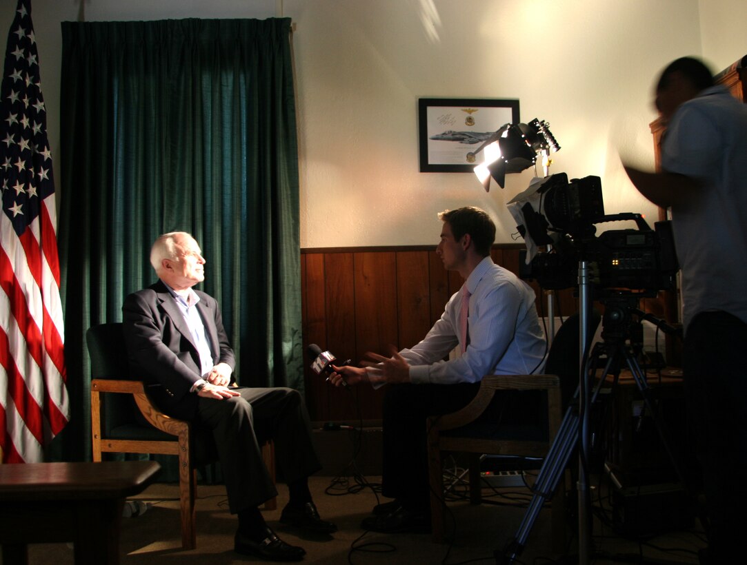 Arizona Sen. John McCain speaks with Adam Mertz, KYMA 11 news anchor, during a visit to the Marine Corps Air Station in Yuma, Ariz., July 17, 2009. While visiting the air station, McCain heard about the potential future basing of the F-35B Lightning II Joint Strike Fighter and re-enlisted Staff Sgt. James Daponte, a Headquarters and Headquarters Squadron Marine.(Photo by Cpl. Pete Zrioka)