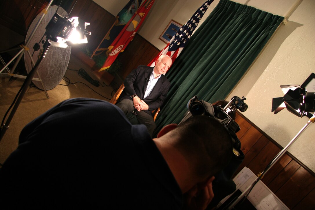 Arizona Sen. John McCain speaks with a local reporter during a visit to the Marine Corps Air Station in Yuma, Ariz., July 17, 2009. While visiting the air station, McCain heard about the potential future basing of the F-35B Lightning II Joint Strike Fighter and re-enlisted Staff Sgt. James Daponte, a Headquarters and Headquarters Squadron Marine.(Photo by Cpl. Pete Zrioka)