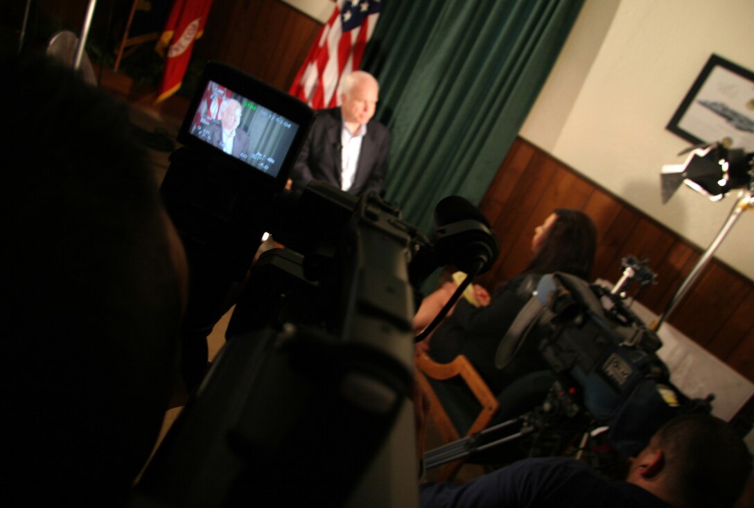 Arizona Sen. John McCain speaks with Gaby Gonzalez, KSWT 13 news anchor, during a visit to the Marine Corps Air Station in Yuma, Ariz., July 17, 2009. While visiting the air station, McCain heard about the potential future basing of the F-35B Lightning II Joint Strike Fighter and re-enlisted Staff Sgt. James Daponte, a Headquarters and Headquarters Squadron Marine.(Photo by Cpl. Pete Zrioka)