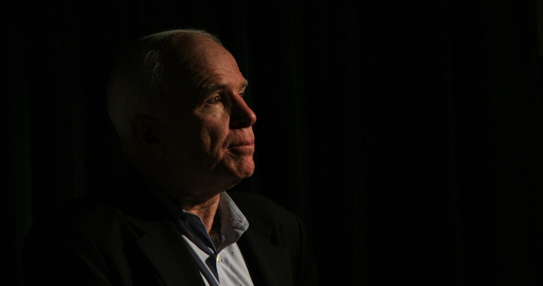 Arizona Sen. John McCain speaks with a local reporter during a visit to the Marine Corps Air Station in Yuma, Ariz., July 17, 2009. While visiting the air station, McCain heard about the potential future basing of the F-35B Lightning II Joint Strike Fighter and re-enlisted Staff Sgt. James Daponte, a Headquarters and Headquarters Squadron Marine.