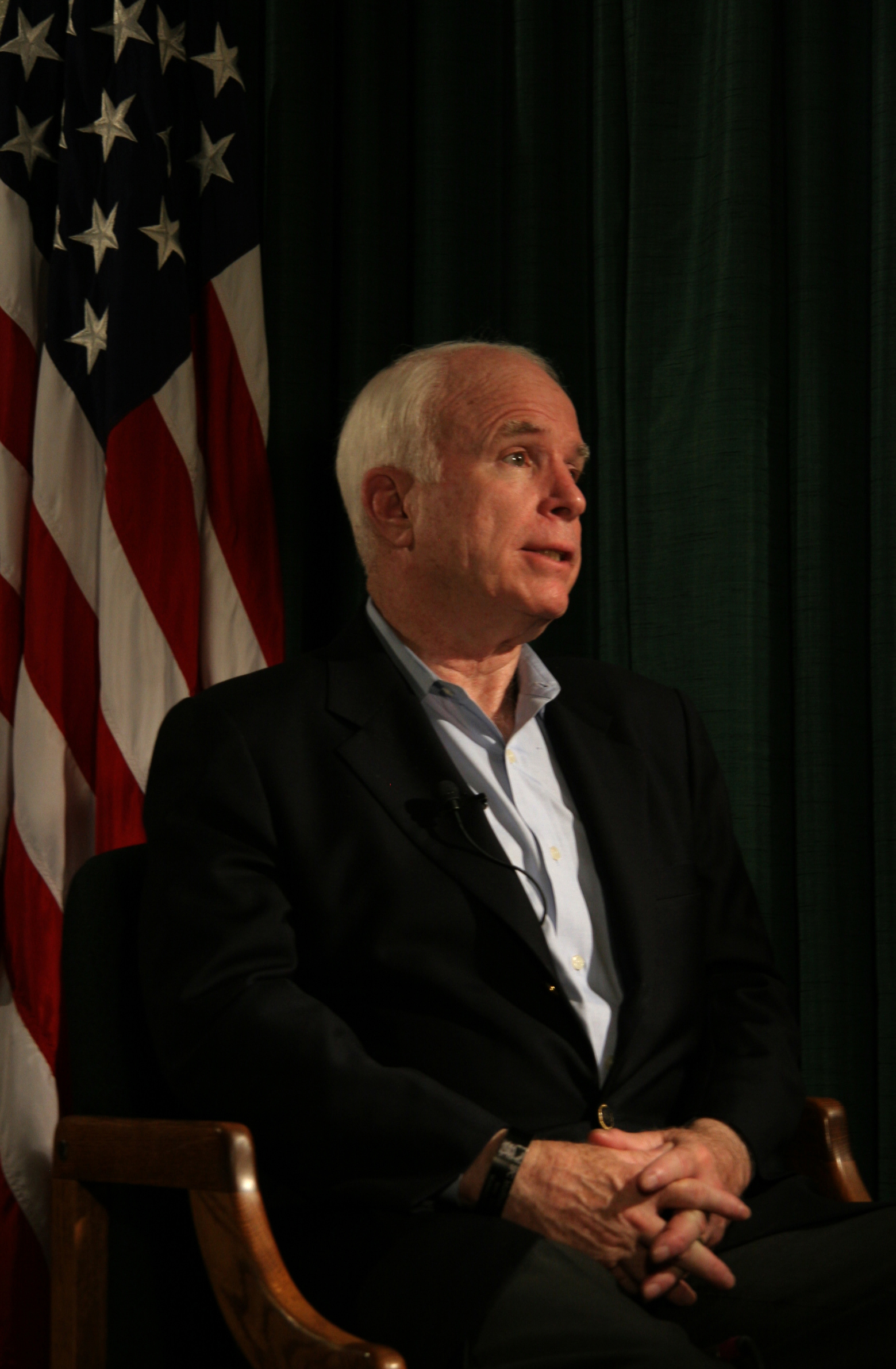 Arizona Sen. John McCain speaks with a local reporter during a visit to the Marine Corps Air Station in Yuma, Ariz., July 17, 2009. While visiting the air station, McCain heard about the potential future basing of the F-35B Lightning II Joint Strike Fighter and re-enlisted Staff Sgt. James Daponte, a Headquarters and Headquarters Squadron Marine.