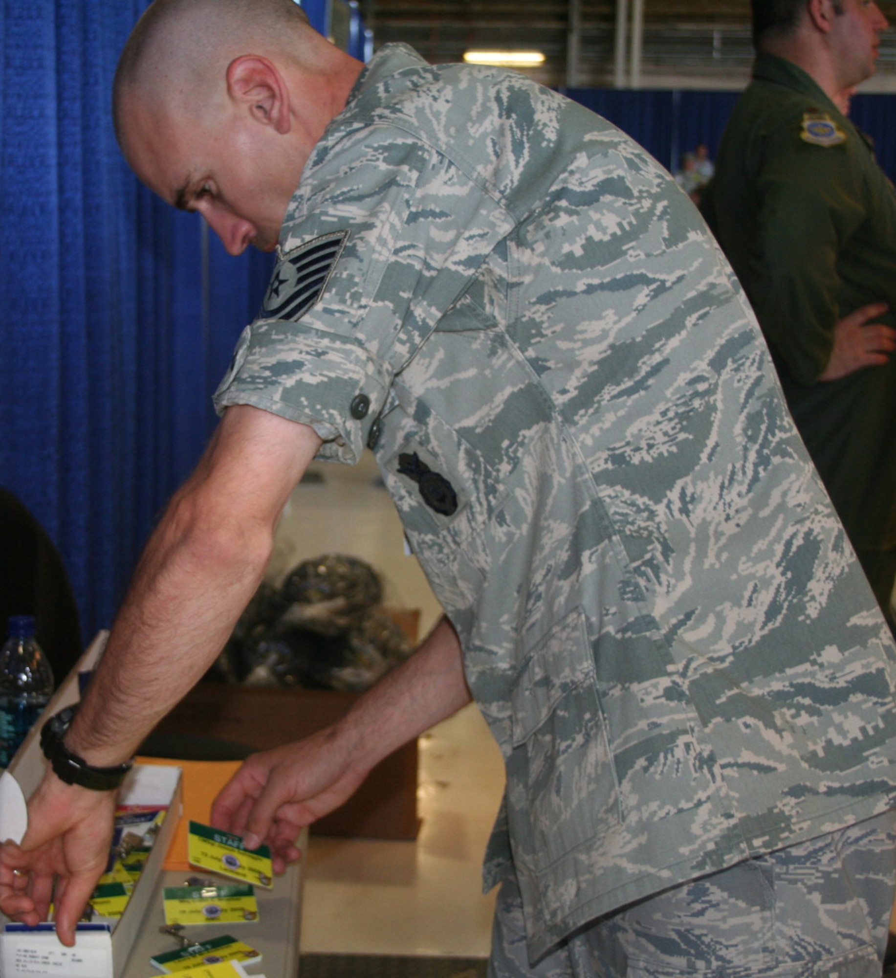 Tech. Sgt. Robert Fitzpatrick, 62nd Security Forces Squadron plans and programs, searches for badges of incoming Air Mobility RODEO personnel July 18, 2009, at McChord Air Force Base, Wash. Sergeant Fitzpatrick’s job is to ensure that all personnel have the proper badges and vehicle passes so that they can get to their respective RODEO functions.  (U.S. Air Force Photo/Airman 1st Class Amber Kelly-Herar)
