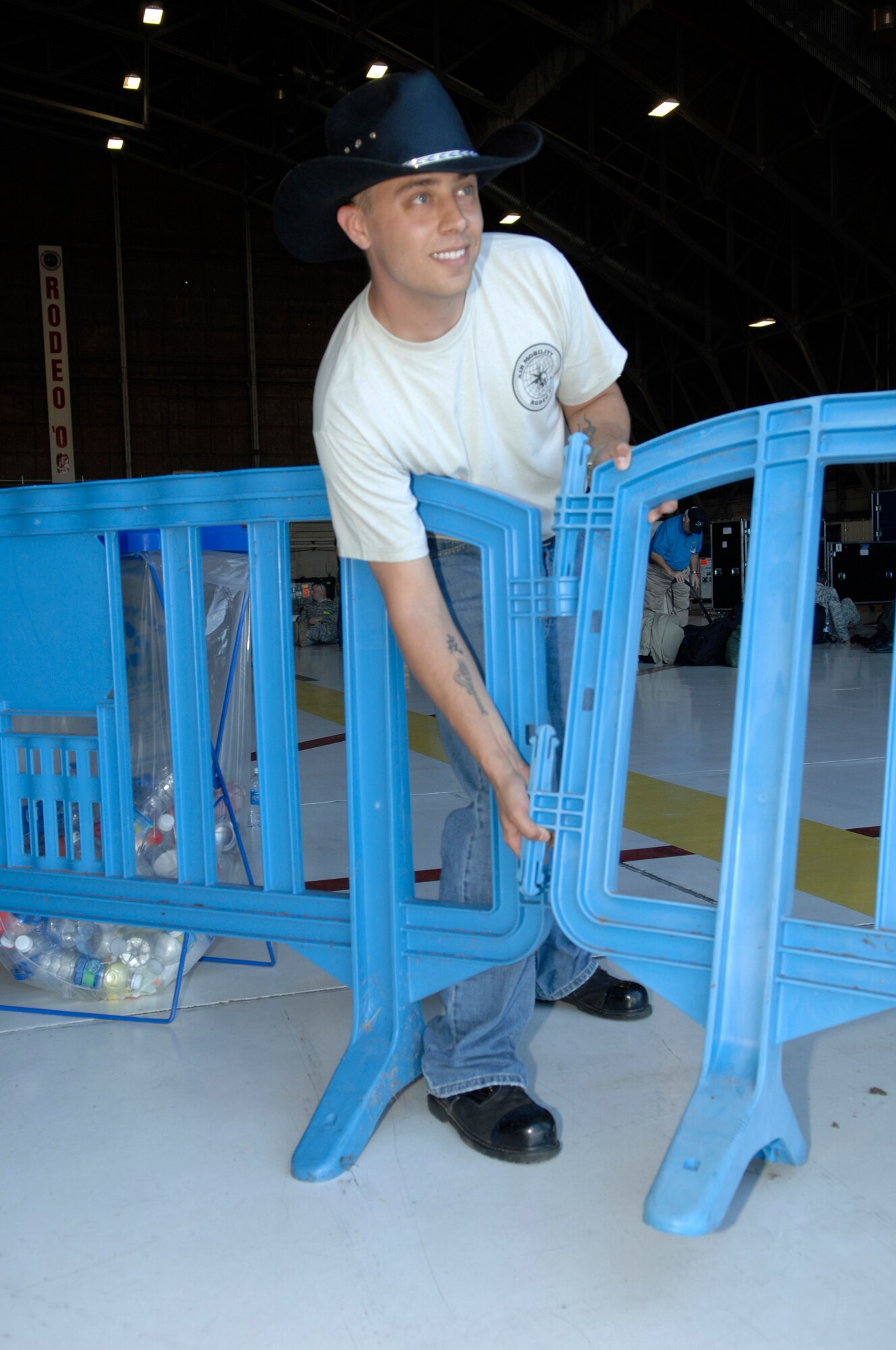 Staff Sgt. Josh Vaught, 446th Aircraft Maintenance Squadron and a "Wrangler" for Air Mobility Command's RODEO 2009, moves barricades July 18 in Hangar 4 at McChord Air Force Base, Wash. RODEO Wranglers direct participants and help ensure things go smoothly throughout the course of the RODEO events. (U.S. Air Force Photo/Senior Airman Matthew Smith)