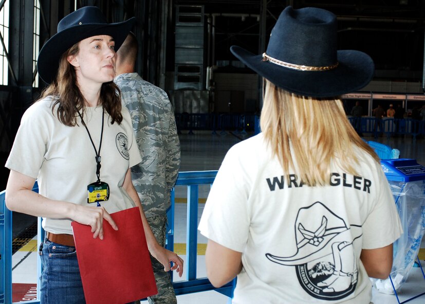 Capt. Andrea Barry, 446th Maintenance Squadron and a "Wrangler" for Air Mobility Command's RODEO 2009, discusses the day's events in Hangar 4 July 18, 2009, prior to the arrival of RODEO teams from other bases and around the world. RODEO Wranglers are volunteers who are responsible for meeting and greeting participants. (U.S. Air Force photo/Senior Airman Emerald Ralston)