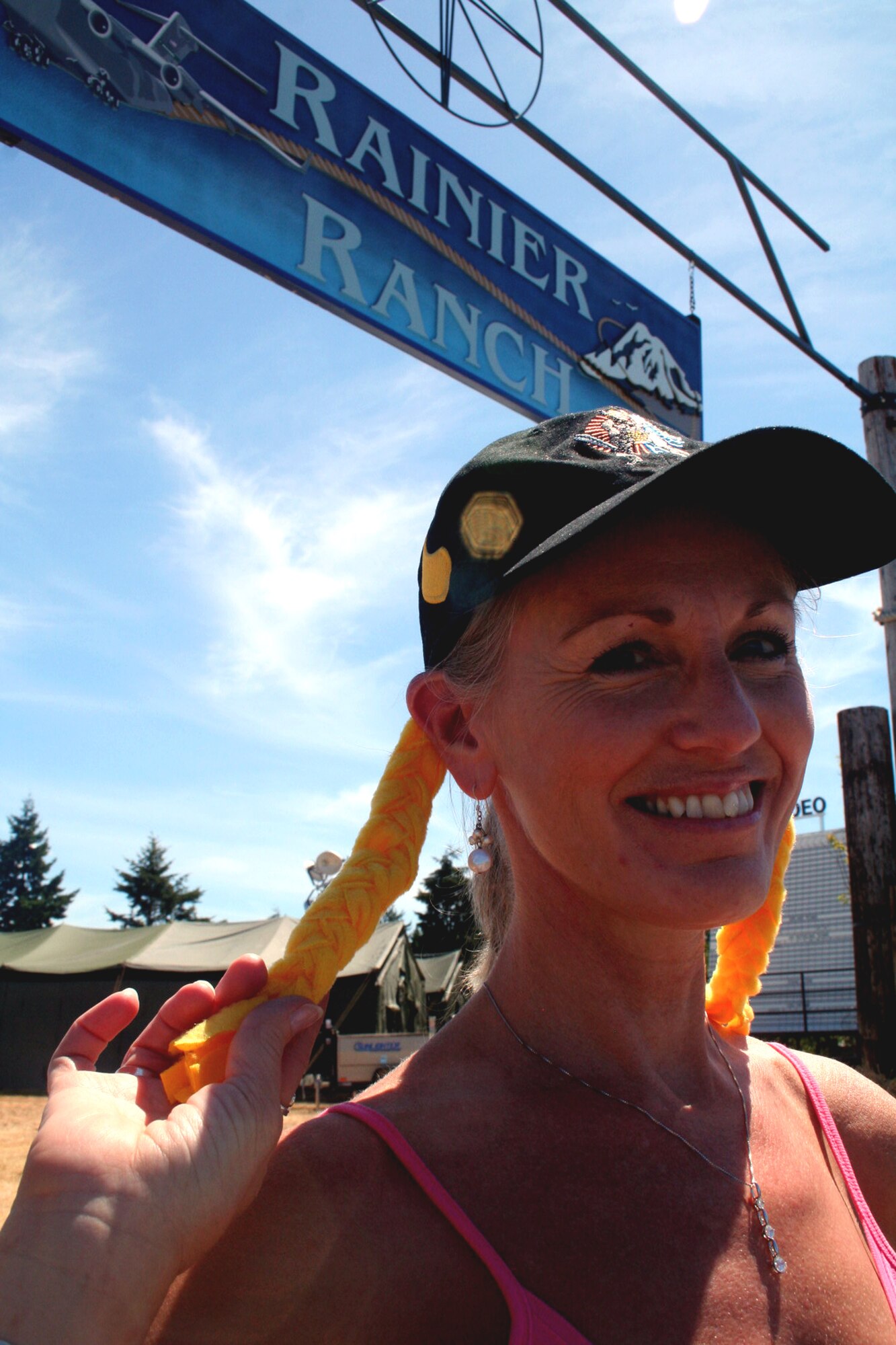 Ms. Julie McWalter, marketing director for the 319th Force Support Squadron at Grand Forks Air Force Base, N.D., displays the hat she'll be wearing for festivities in Rainier Ranch on McChord Air Force Base, Wash., July 18, 2009.  Rainier Ranch serves as "entertainment central" for Air Mobility Command's RODEO 2009.  The ranch is an open space holding 46 tents where some of the more than 100 teams participating in RODEO can display items from their unit, base or country.  (U.S. Air Force Photo/Tech. Sgt. Scott T. Sturkol)