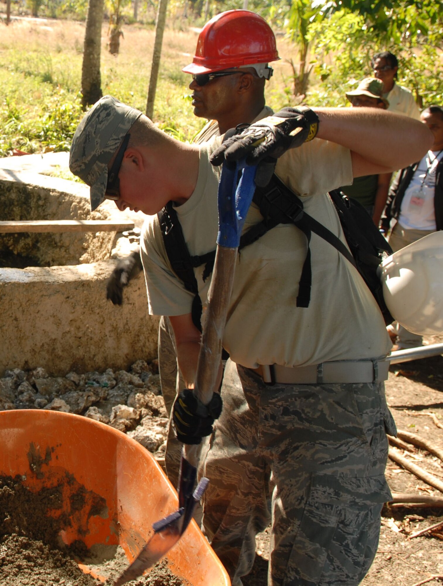 Air Force civil engineers deployed to Naioni, Indonesia, as part of Operation Pacific Angel 2009 mix concrete to form a base for a water distribution pump for a rural village July 17. The Airmen worked with Indonesian military members and civilians to install one water pump and over 900 feet of water distribution lines connecting to a water storage tank. Pacific Angel is a Pacific Air Forces humanitarian and civic assistance operation led by 13th Air Force at Hickam Air Force Base, Hawaii. (U.S. Air Force photo/Senior Master Sgt. Russell Dodson)