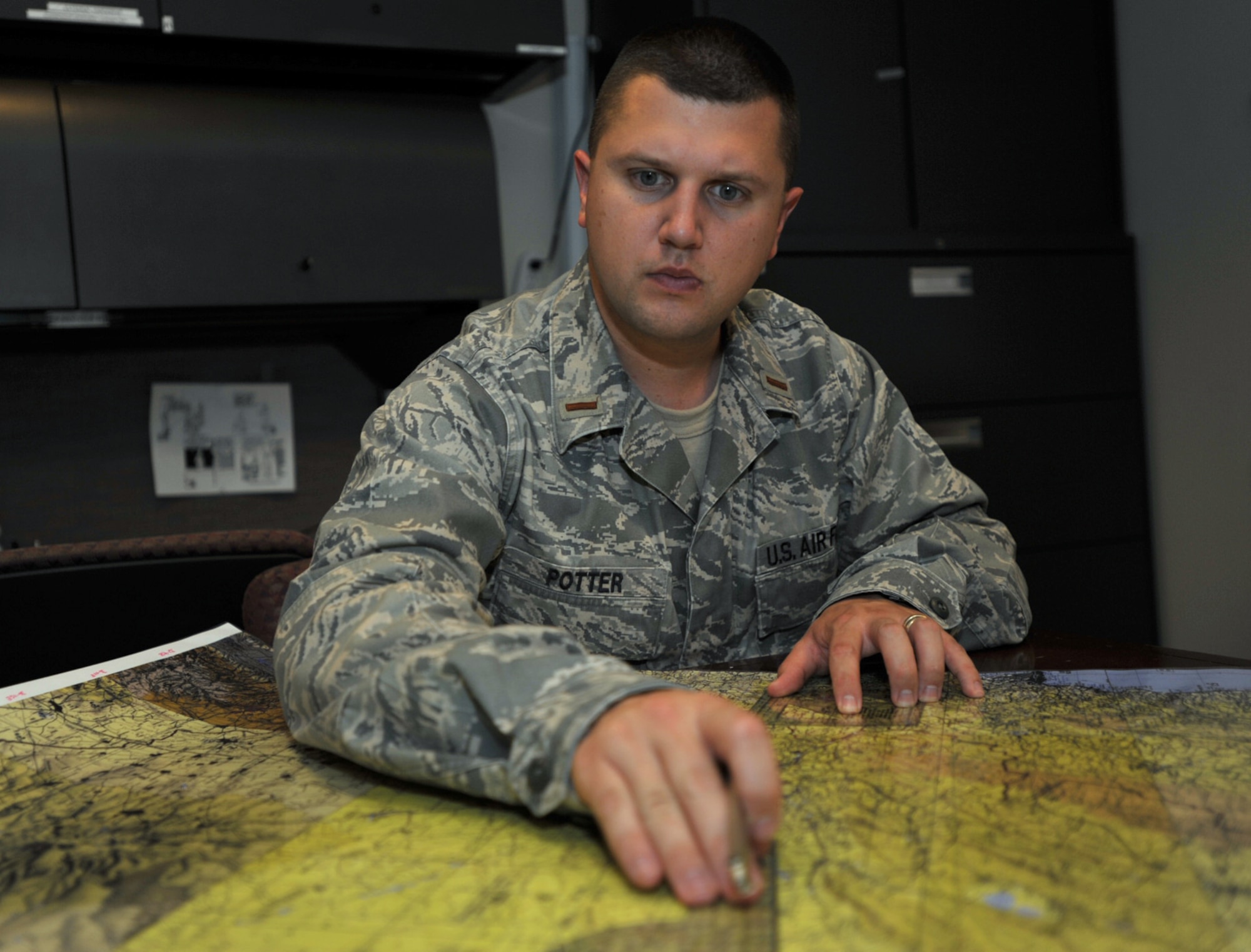 2nd Lt. Travis Potter uses a map for intelligence training during the 931st Air Refueling Group's drill weekend in July. Lieutenant Potter, an intelligence officer assigned to the 931st Operations Support Flight, was recently selected for promotion to first lieutenant. (U.S. Air Force photo/Tech. Sgt. Jason Schaap)