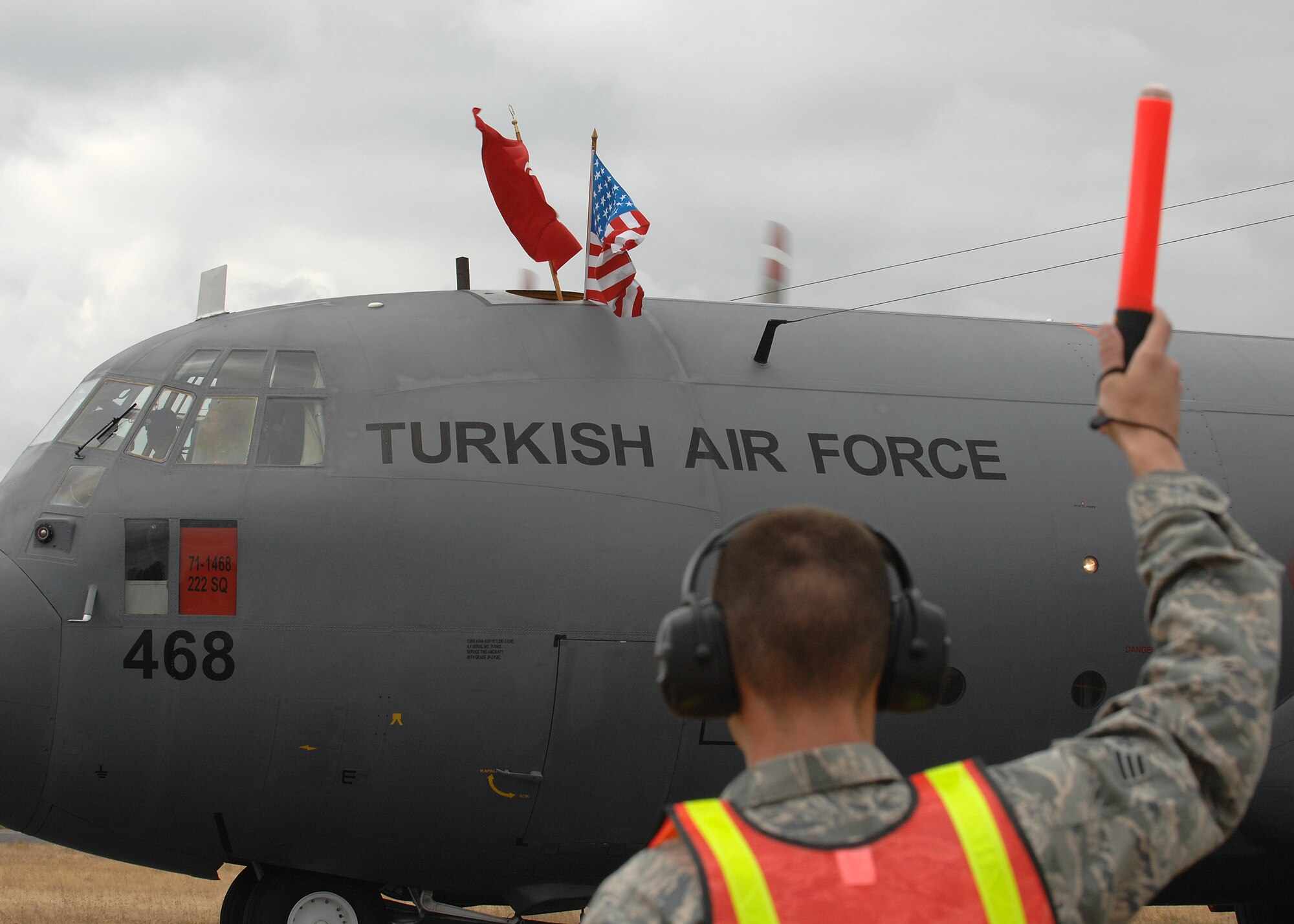 U.S. Air Force Senior Airman Luke Richardson from the 62nd Aircraft Maintenance Squadron, McChord AFB, WA, marshals in a Turkish Air Force C-130 Aircraft during the international competitor arrivals for AMC Rodeo 2009, McChord AFB, WA, July 13, 2009. RODEO is an international combat skills and flying operations competition designed to develop and improve techniques and procedures with our international partners to enhance mobility operations (U.S. Air Force photo by SSgt Stephen Schester/Released)  