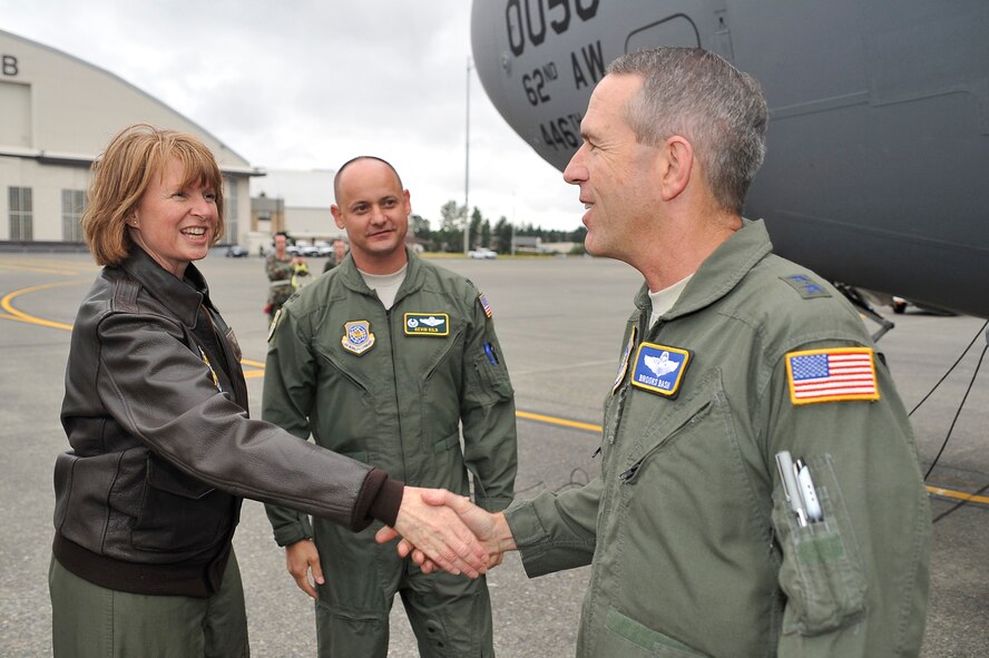 U.S. Air Force Col. Lisa Tank and Col. Kevin Kilb greet Maj. Gen. Brooks Bash at McCord Air Force Base, Wash., July 12, 2009. Gen. Bash arrived at McCord as the commander for RODEO 2009. Col.Tank is the acting commander of the 446th Airlift Wing. Col. Kilb is the commander, 62nd Airlift, are both from McChord AFB, Wash. Air Mobility RODEO is an international combat skills and flying operations competition designed to develop and improve techniques, procedures, and interoperability with our international partners to enhance mobility operations. (U.S. Air Force photo by James M. Bowman/released)