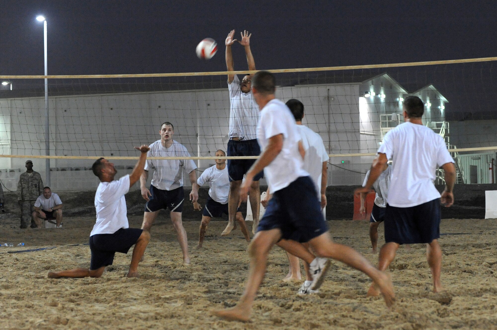 SOUTHWEST ASIA - 380th Air Expeditionary Wing members participate in the championship volleyball game July 15. The 380th Expeditionary Civil Engineer Squadron, Fire Dawgs-A team won the championship game versus the 380th Expeditionary Airborne Air Control Squadron, EAACS-A team two out three games. (U.S. Air Force photo Tech. Sgt. Charles Larkin Sr)