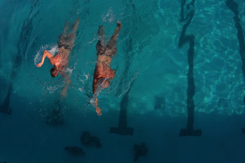 Marines participating in pre-screening for Marine Corps Instructor of Water Survival training swim laps at the training tank July 21.