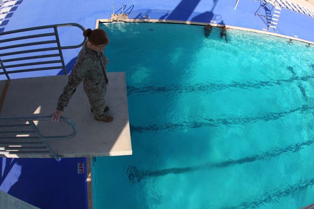 –Sgt. Shelby Vega, a logistics vehicle system operator with Combat Logistics Battalion 7, steps toward the edge of the second high dive during annual swim qualification training at the training tank July 21.
