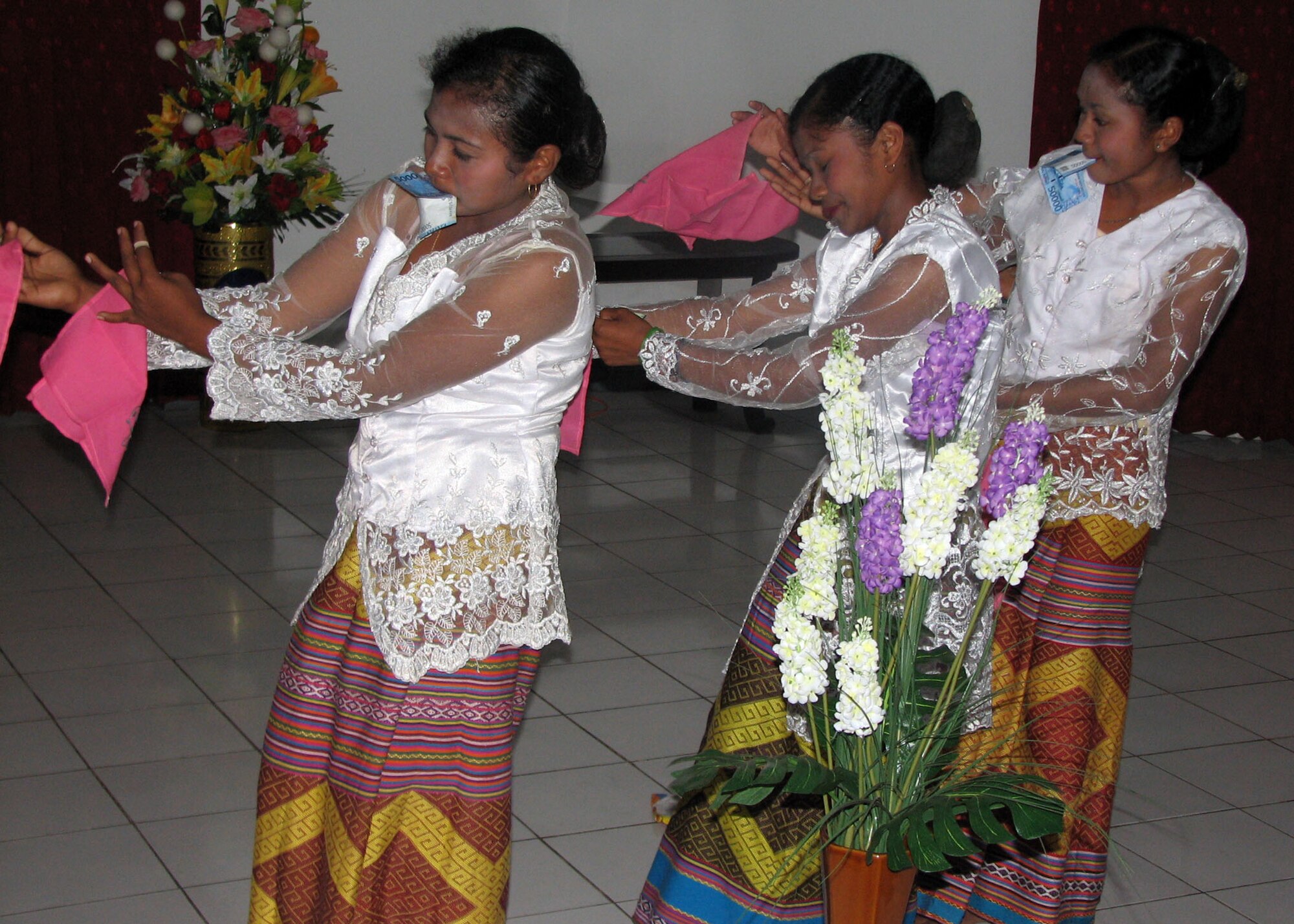 KUPANG, Indonesia — Local Indonesian women perform a traditional dance July 19 at the home of Dr. Ayub Titu Eki, the top government official of the Kupang region. Dr. Eki invited U.S. members of the Operation Pacific Angel 2009 team to his home here for an evening of entertainment, food and dancing. The U.S. personnel are providing medical, dental and engineering assistance programs to underserved areas of Indonesia in conjunction with local authorities through July 24. Pacific Angel is a Pacific Air Forces humanitarian and civic assistance program conducted in the Asia-Pacific region and led by 13th Air Force at Hickam Air Force Base, Hawaii. (U.S. Air Force photo/Senior Master Sgt. Russell Dodson)    