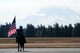 A horse rider carries in the American flag for the opening ceremonies for Air Mobility Command's RODEO 2009 July 19 at McChord Air Force Base, Wash.  More than 100 teams are participating in RODEO competition, including teams from seven foreign countries. RODEO is the U.S. Air Force's and AMC's premier air mobility competition. It's an international combat skills and flying operations competition designed to develop and improve techniques, procedures and interoperability with international partners to optimize mobility partnerships and enhance mobility operations. (U.S. Air Force Photo/Tech. Sgt. Scott T. Sturkol)