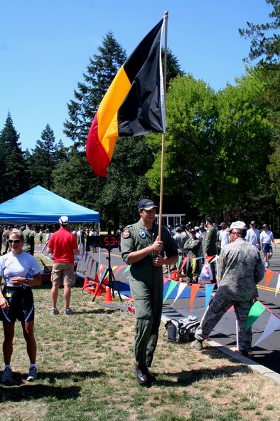 A member of the Belgian air force team cheers on teammates in the fit-to-fight competition for Air Mobility Command's RODEO 2009 July 19 at McChord Air Force Base, Wash.  More than 100 teams are participating in RODEO competition, including teams from seven foreign countries. RODEO is the U.S. Air Force's and AMC's premier air mobility competition. It's an international combat skills and flying operations competition designed to develop and improve techniques, procedures and interoperability with international partners to optimize mobility partnerships and enhance mobility operations. (U.S. Air Force Photo/Tech. Sgt. Scott T. Sturkol)