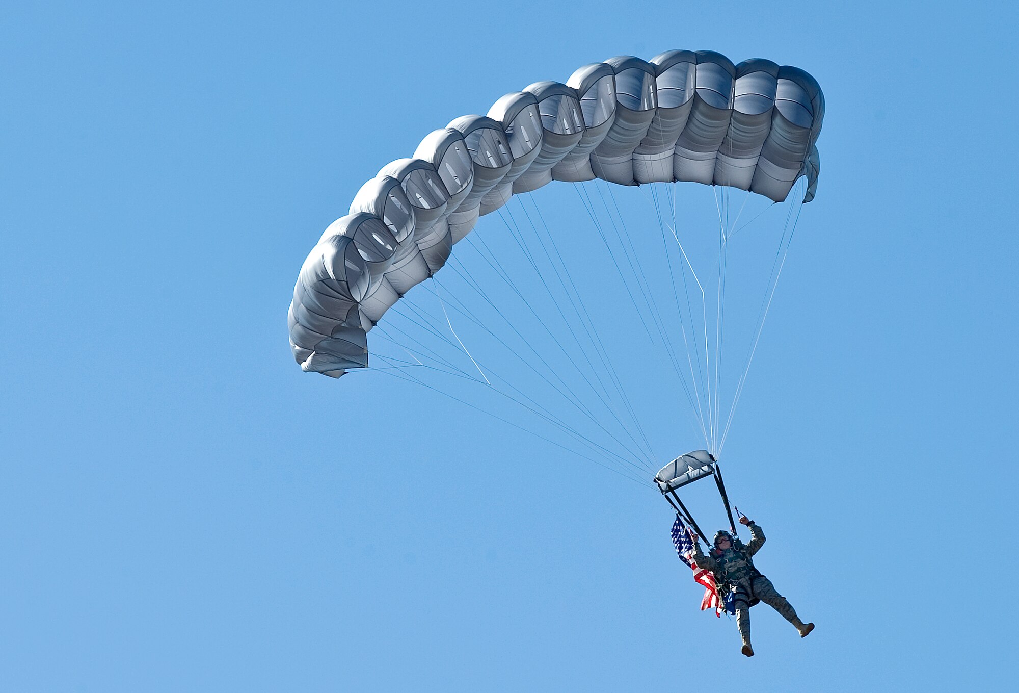 Master Sgt. Jeff Guilmain delivers the American flag with style after parachuting from a C-5 Galaxy during the opening ceremony of the Air Mobility Rodeo 2009 July 19 at McChord Air Force Base, Wash. Sergeant Guilmain is stationed with the 22nd Special Tactics Squadron at McChord AFB. (U.S. Air Force photo/Staff Sgt. Bennie J. Davis III)