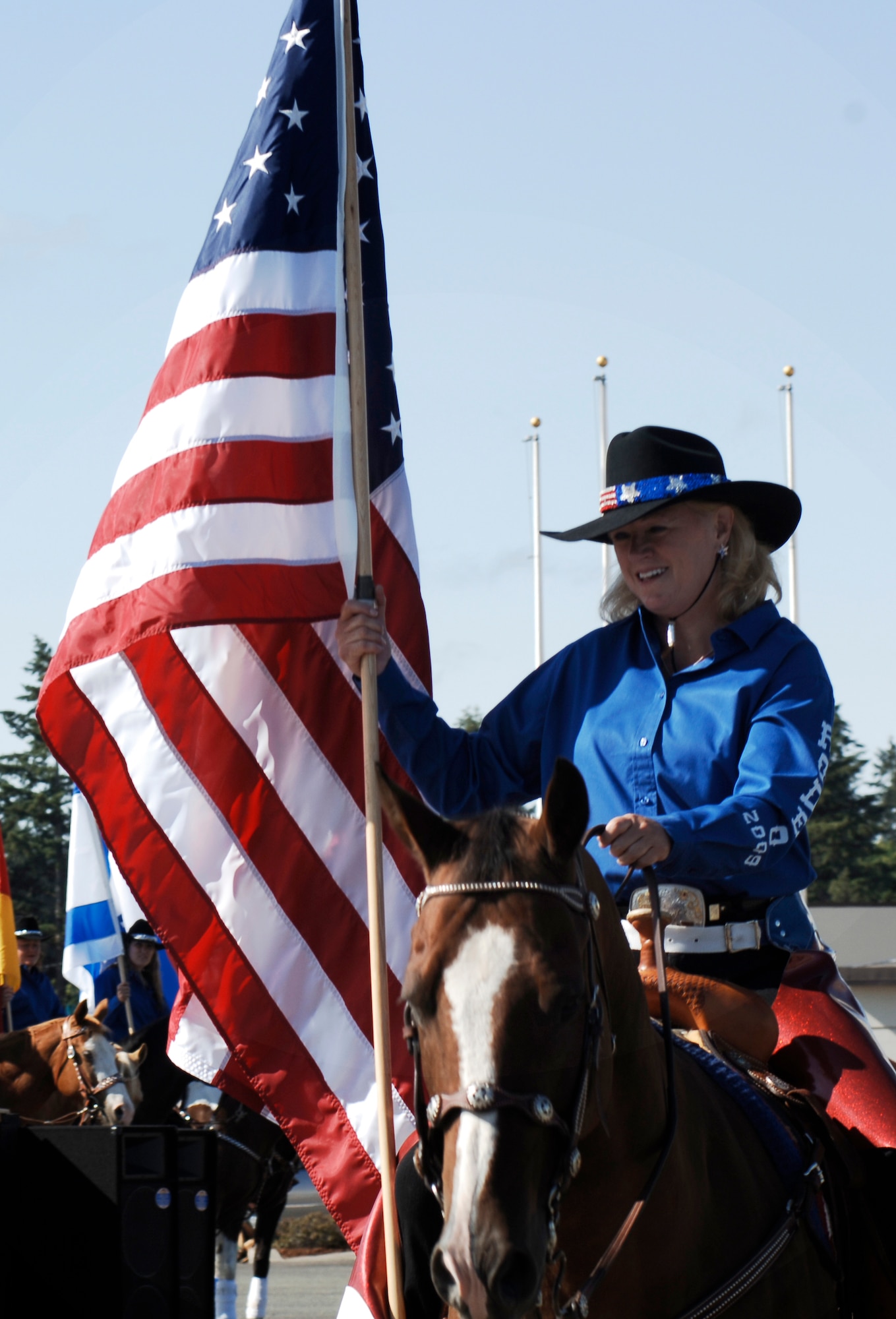MCCHORD AIR FORCE BASE, Wash. -- RODEO 2009 Starlets stand with flags from participating countries from around the world during the opening ceremony July 18. RODEO is an international competition that allows us to team with our international partners to develop skills and ensure joint/coalition forces will win today's fight. (U.S. Air Force photo/Senior Airman Emerald Ralston)