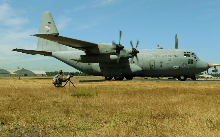 Staff Sgt. Elaine Egger, 4th Combat Camera Squadron, March Air Reserve Base, Calif., rolls video footage of a C-130 Hercules during Air Mobility RODEO 2009, at McChord Air Force Base, Wash., July 18. RODEO is an international combat skills and flying operations competition designed to develop and improve techniques and procedures with our international partners to enhance mobility operations. (U.S. Air Force photo by Tech. Sgt. Michelle Larche)