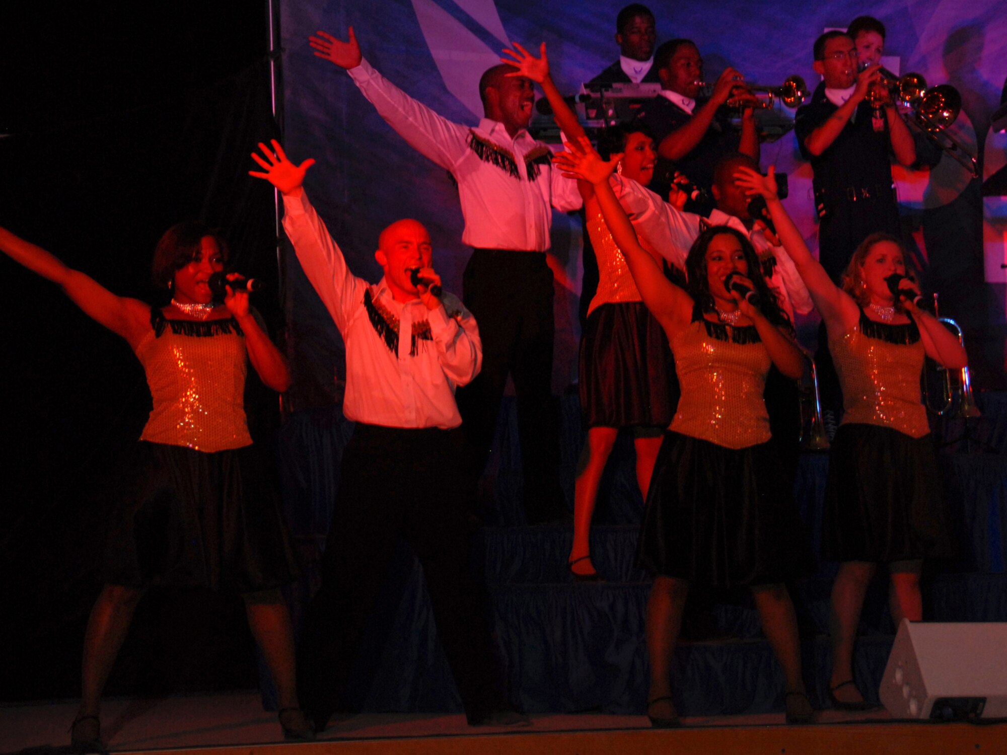 Members of Tops in Blue, the Air Force's premier entertainment showcase, perform for an audience of deployed U.S. and coalition forces in Southwest Asia July 14. Tops in Blue serves as an expeditionary entertainment unit that provides quality entertainment from within Air Force resources to personnel stationed worldwide and at deployed locations while simultaneously promoting community relations, supporting recruiting efforts and serving as ambassadors for the United States. (U.S. Air Force Photo/Tech Sgt. Jason W. Edwards)