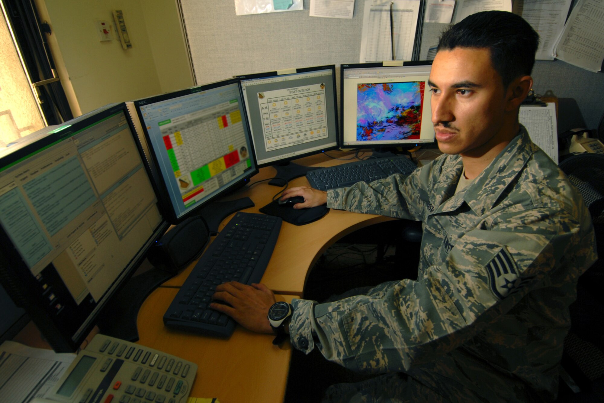 Staff Sgt. Esteban Acosta, 379th Expeditionary Operations Support Squadron
Weather Flight, observes weather conditions, issues weather advisories, watches, and warnings while also forecasting weather conditions in Southwest Asia. The 379 EOSS Weather Flight provides around-the-clock weather service in support of Coalition ground and air forces in Southwest Asia. Sergeant Acosta, a native of El Paso, TX, is deployed from Yakota Air Base, Japan, in support of Operations Iraqi and Enduring Freedom. (U.S. Air Force Photo/Tech Sgt. Jason W. Edwards)